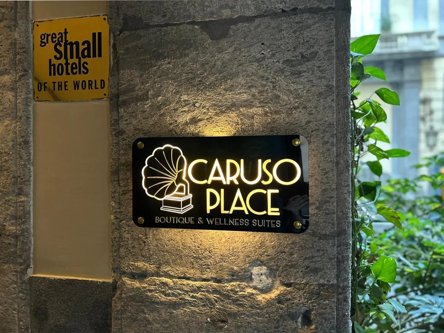 Property logo or sign in Caruso Place Luxury Rooms & Suites