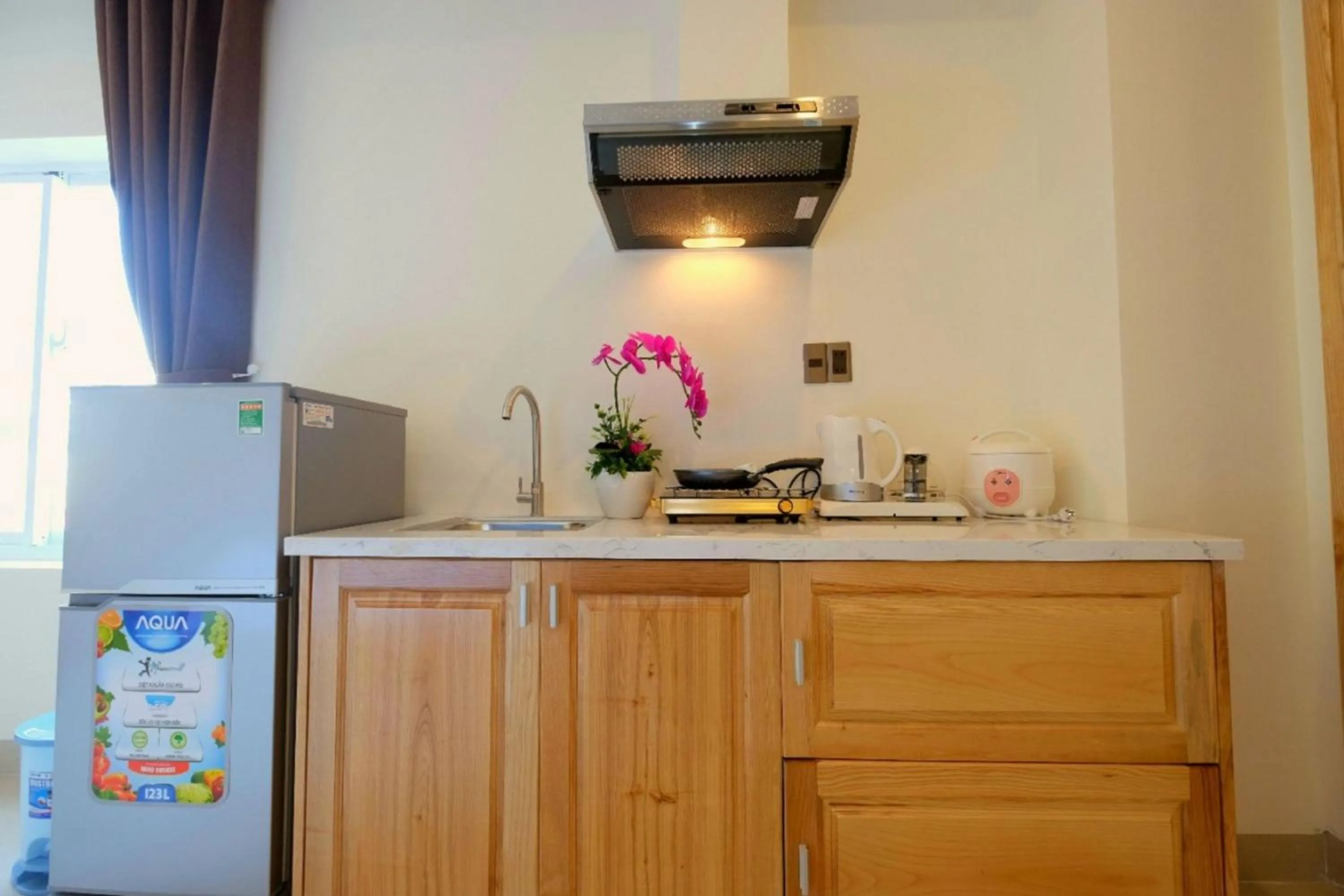 Kitchen or kitchenette in Marigold Hotel & Apartment