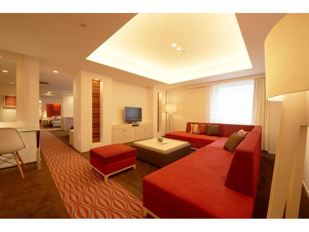 Communal lounge/ TV room, Bed in Kokusai 21 International Hotel