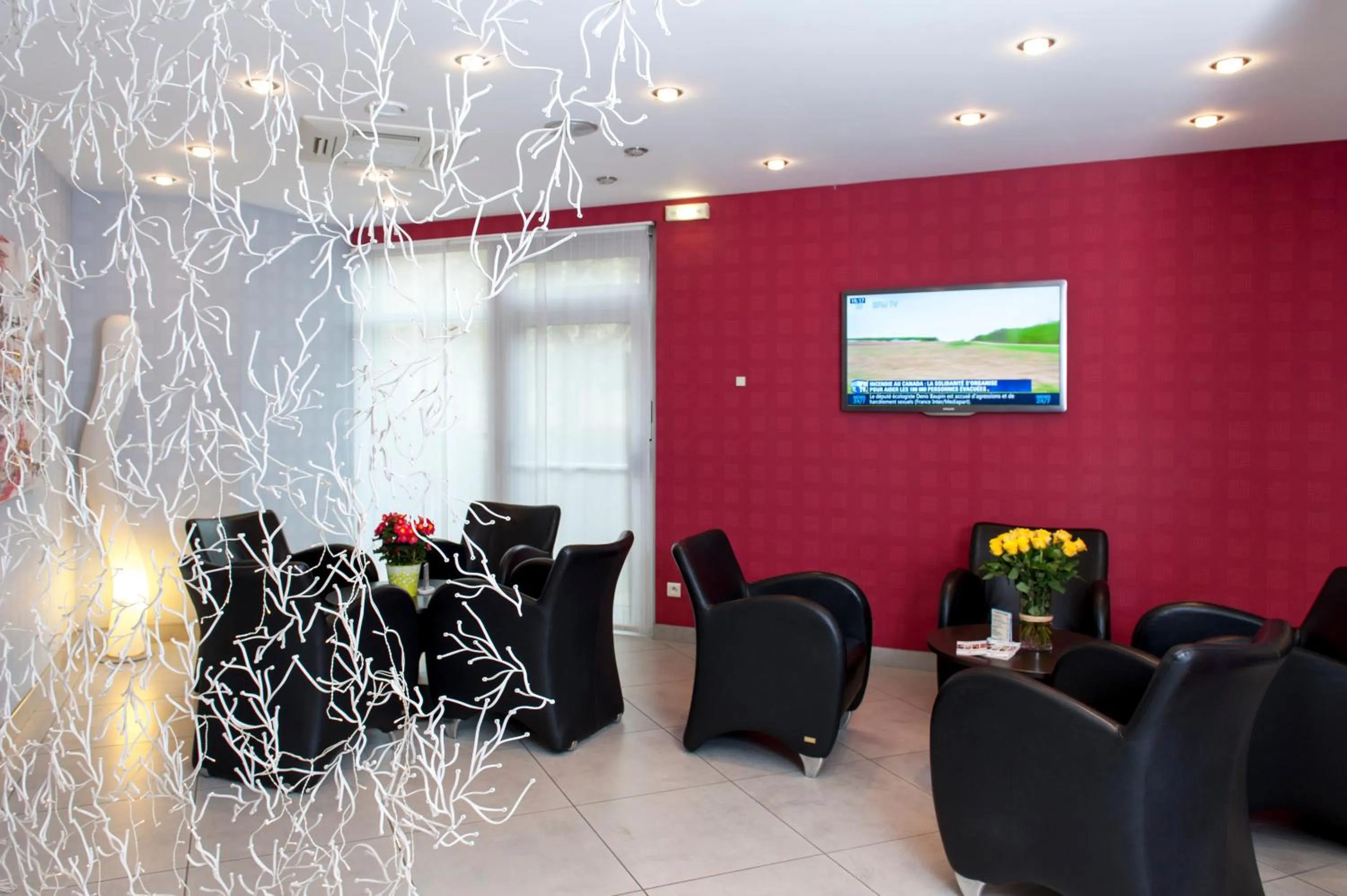 Communal lounge/ TV room in Brit Hotel Belfort Centre-Le Boreal