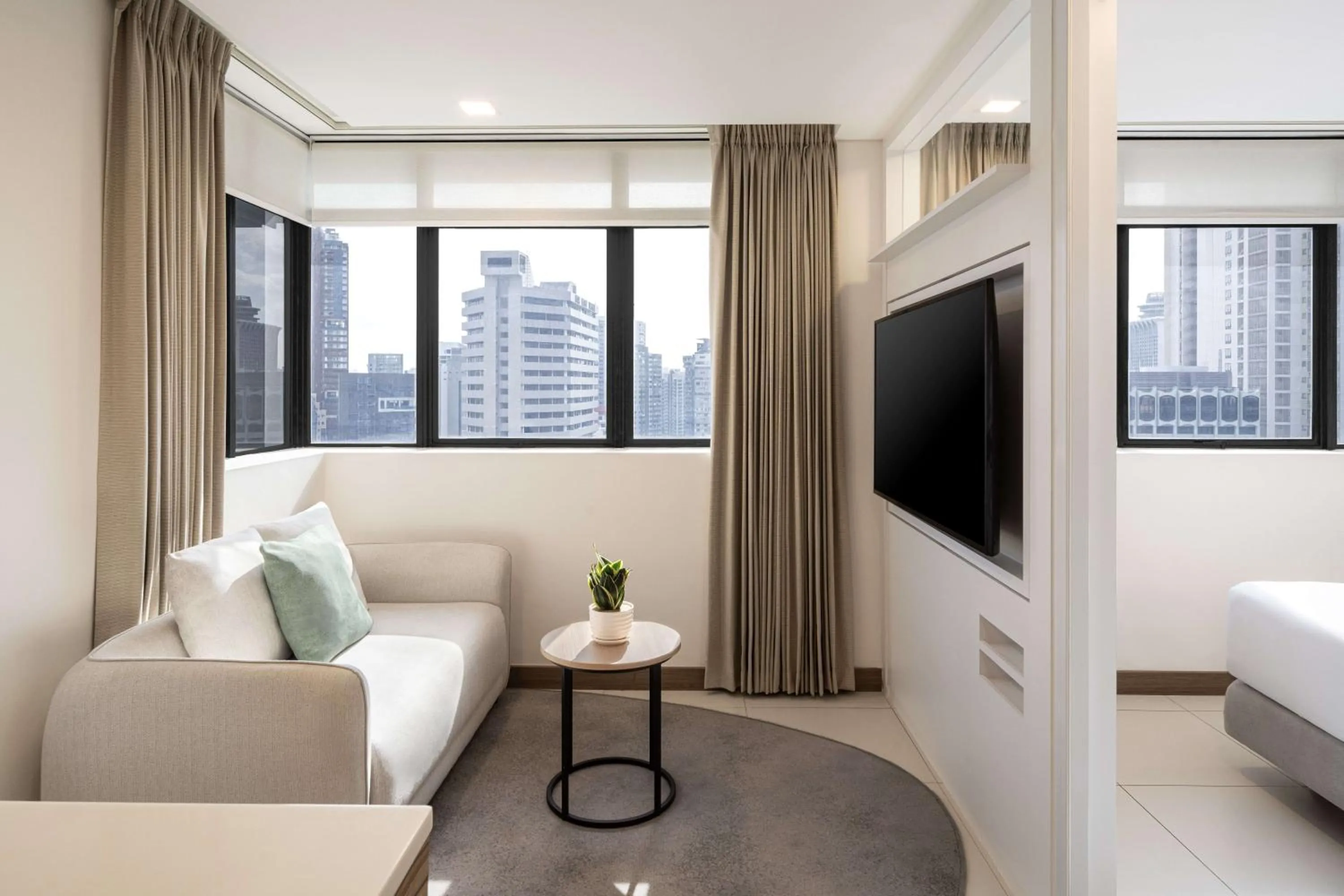 Living room, Bed in Novotel Living Singapore Orchard