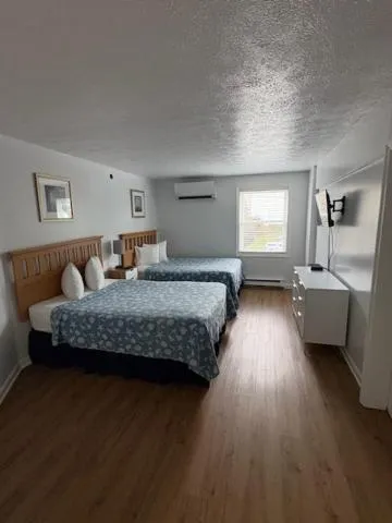 Bed in The Grand Beach Inn