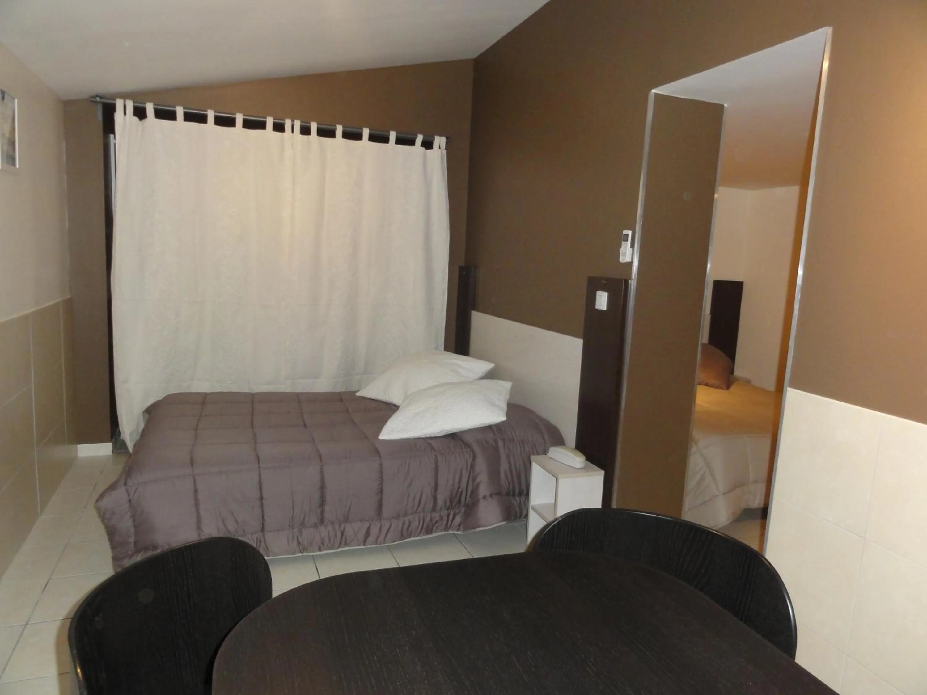 Photo of the whole room, Bed in Hôtel L'Hacienda