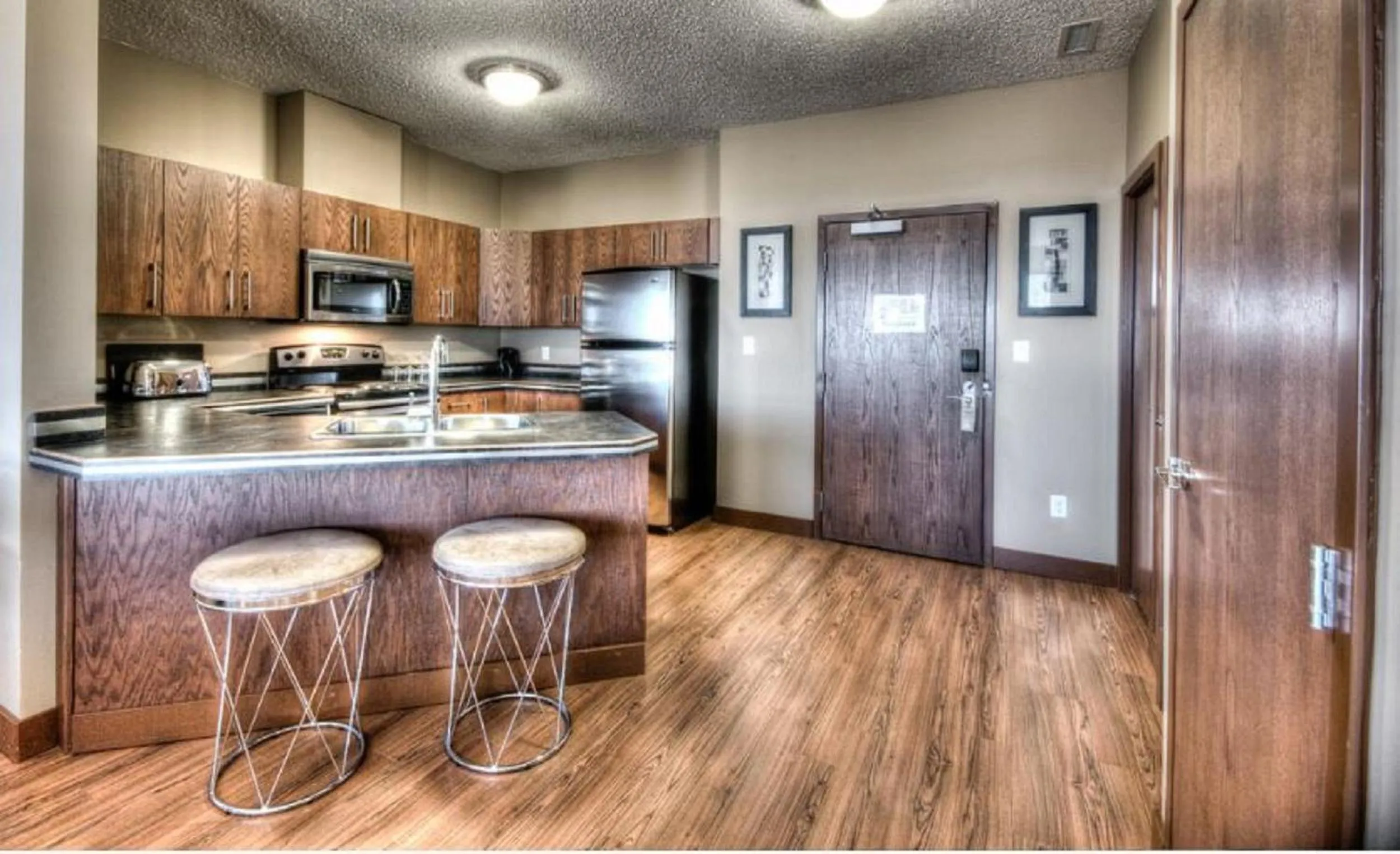 Kitchen or kitchenette in Grand Inn & Residence- Grande Prairie