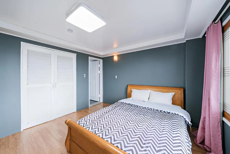 Bed in jeju Tovice Condo Ocean