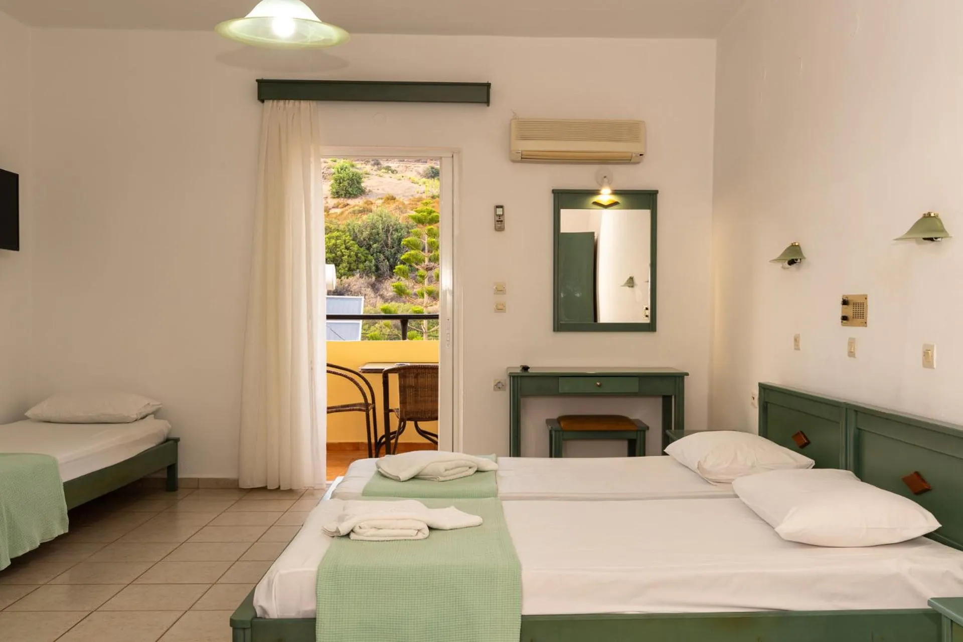 Bed in Elpis Studio Apartments