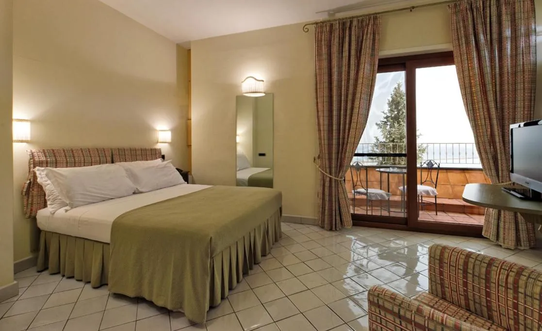 Bed in Villa Poseidon -Boutique Hotel-