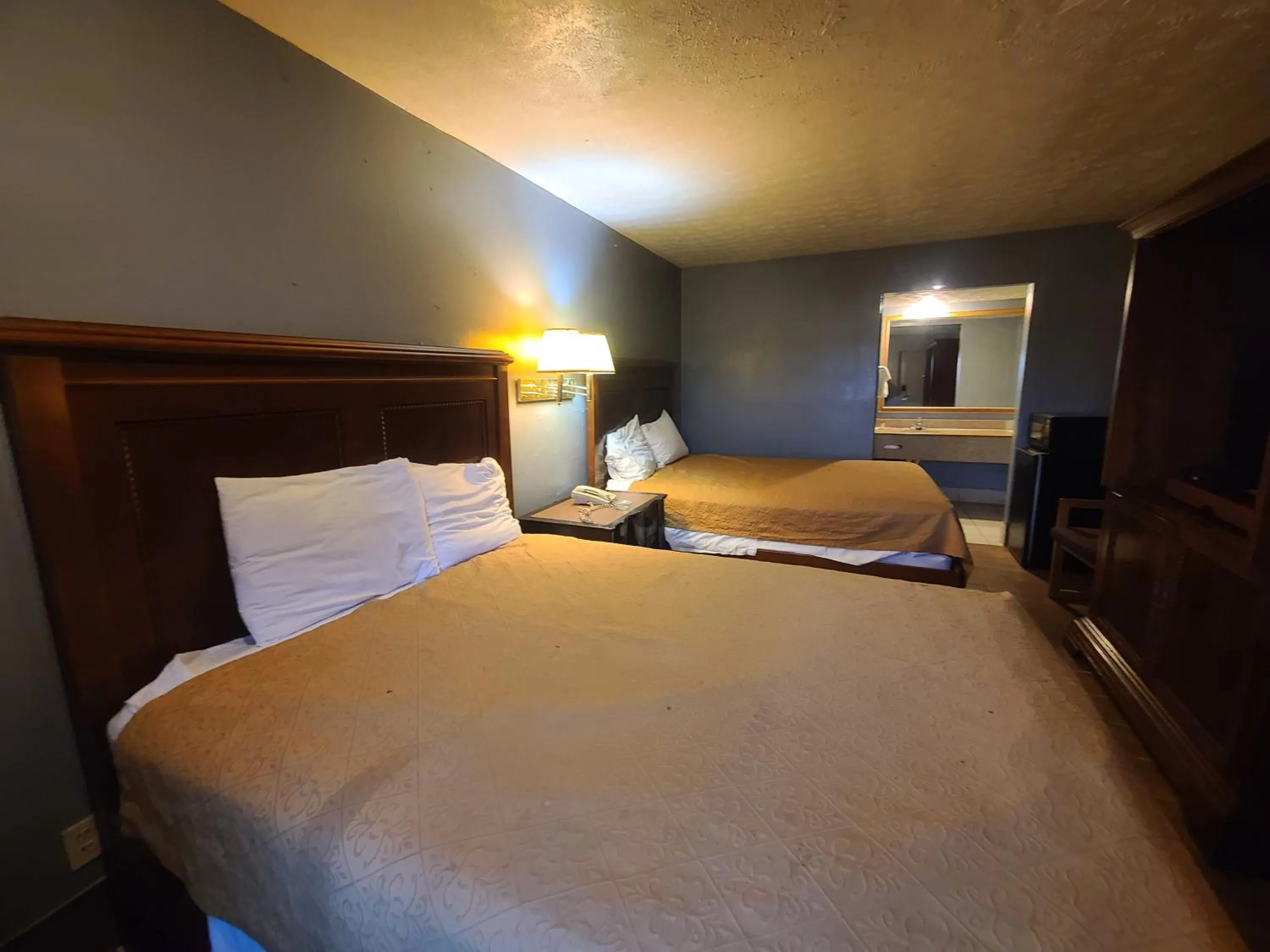 Bed in Garden Inn and Extended Stay