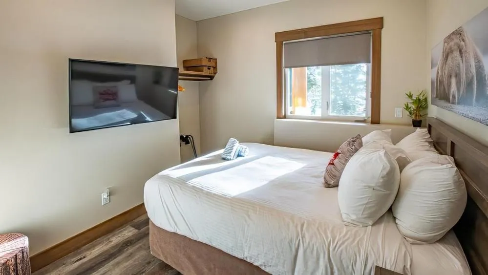 Bed in Snow Creek Cabins by Fernie Lodging Co