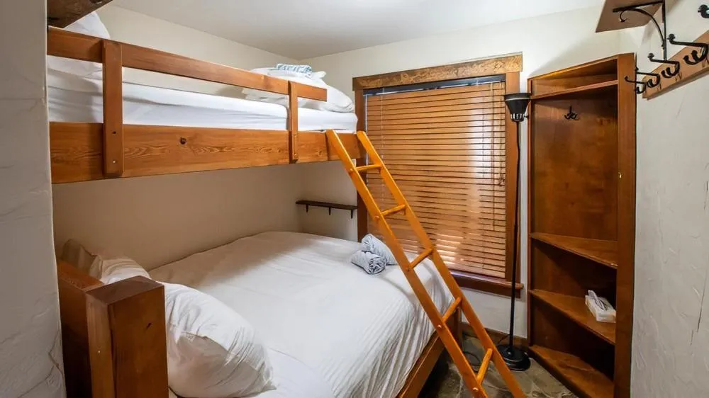 Bed in Snow Creek Cabins by Fernie Lodging Co