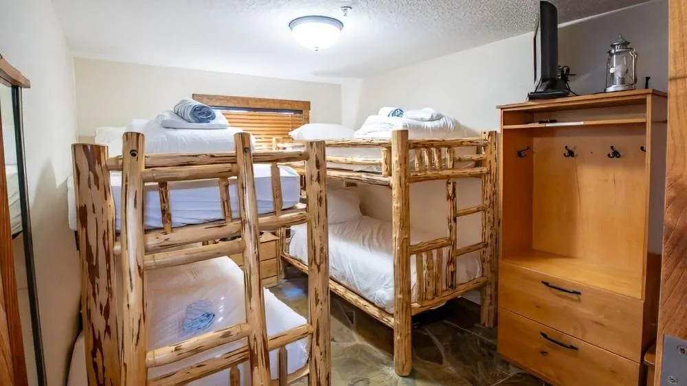 Bed in Snow Creek Cabins by Fernie Lodging Co