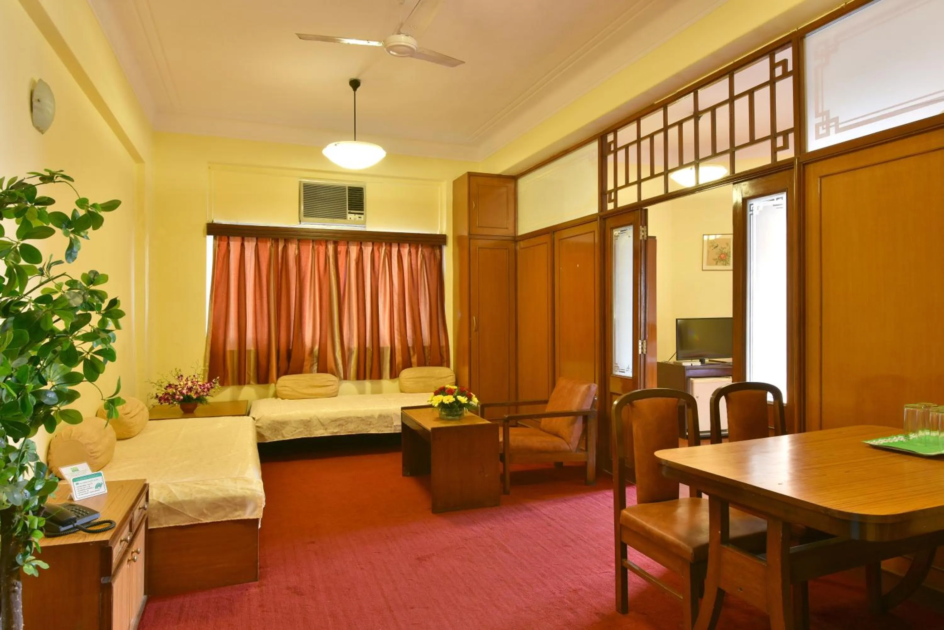 Seating area, Bed in Sea Green South Hotel