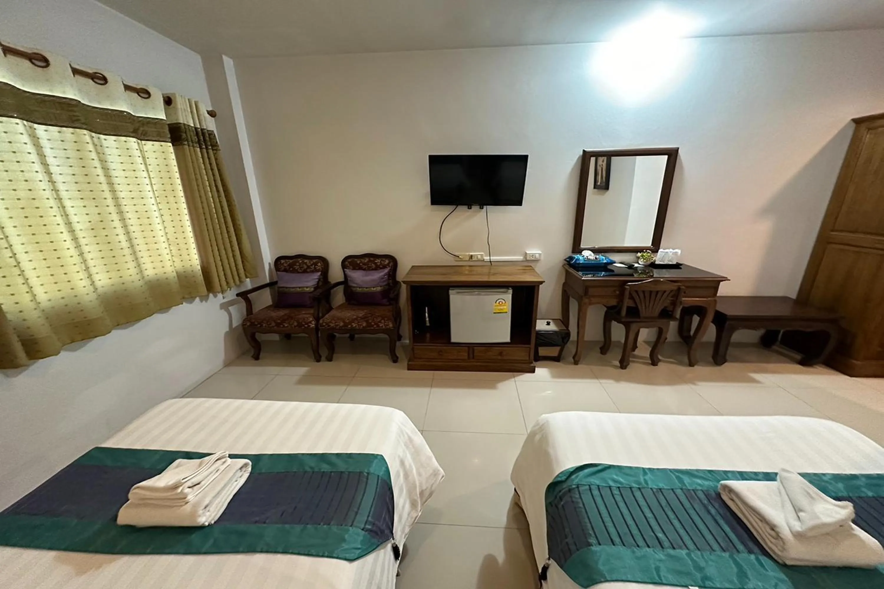 Bed in Chiangrai Grand Room Hotel