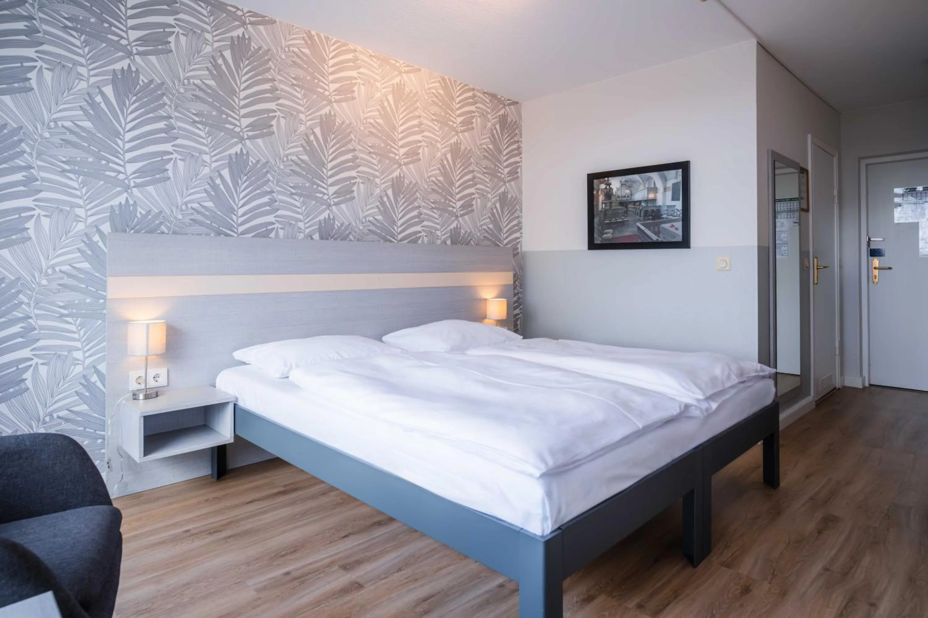 Photo of the whole room, Bed in Hotel des Nordens Flensburg Wellness & Spa