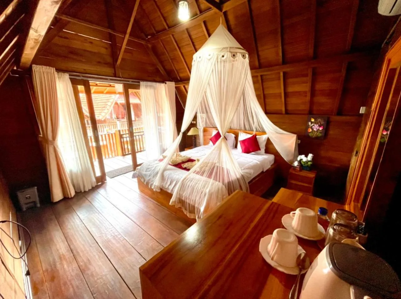 Bed in Ayu Laba Beach Villa and Resto