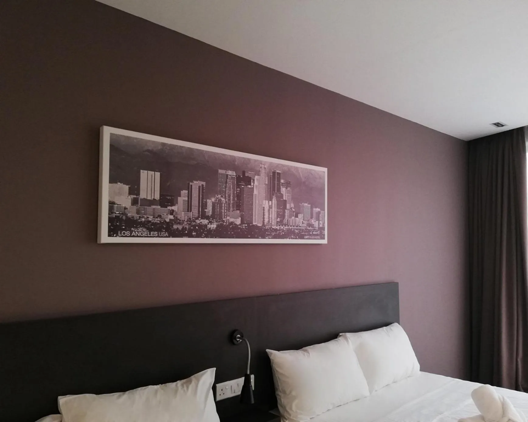 Bed in The Loft Plaza Hotel