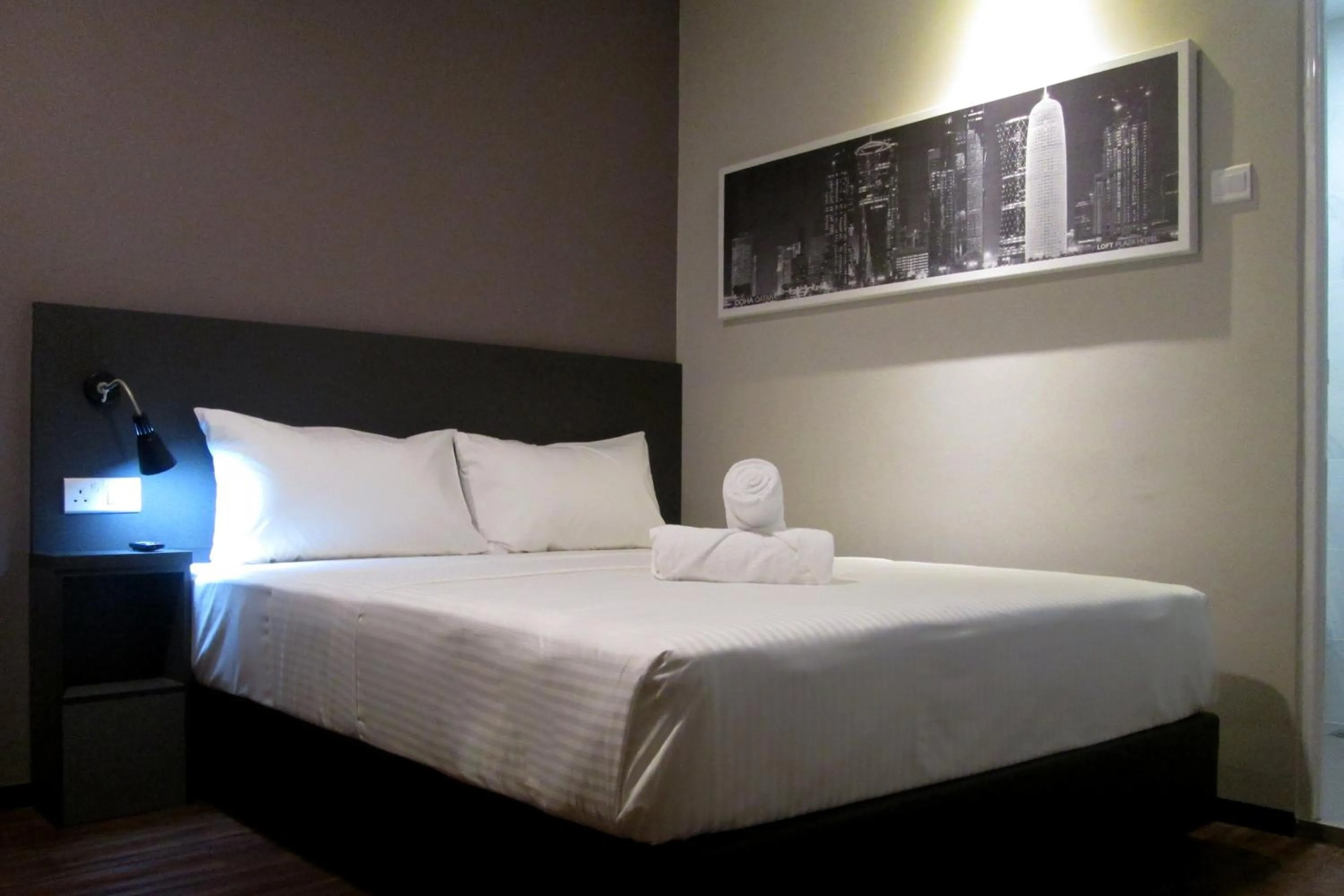 Bed in The Loft Plaza Hotel