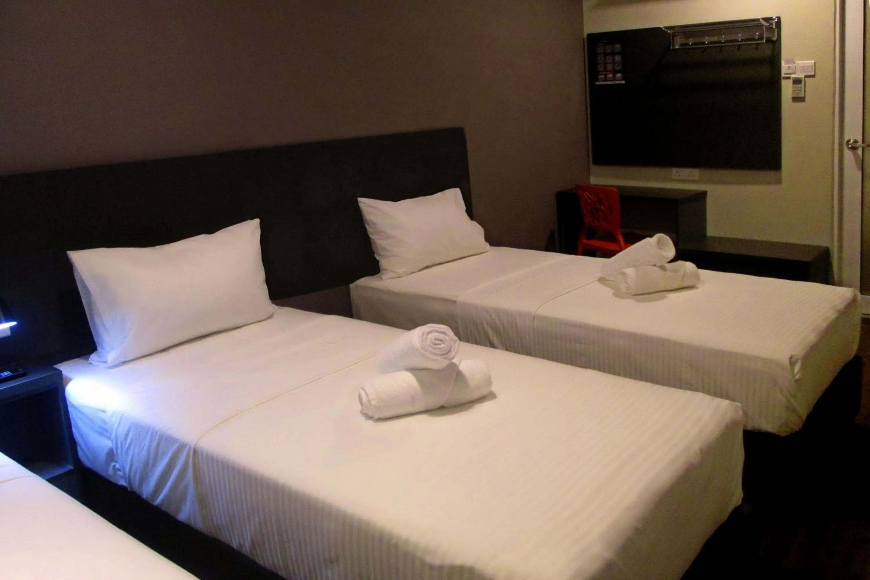 Bed in The Loft Plaza Hotel