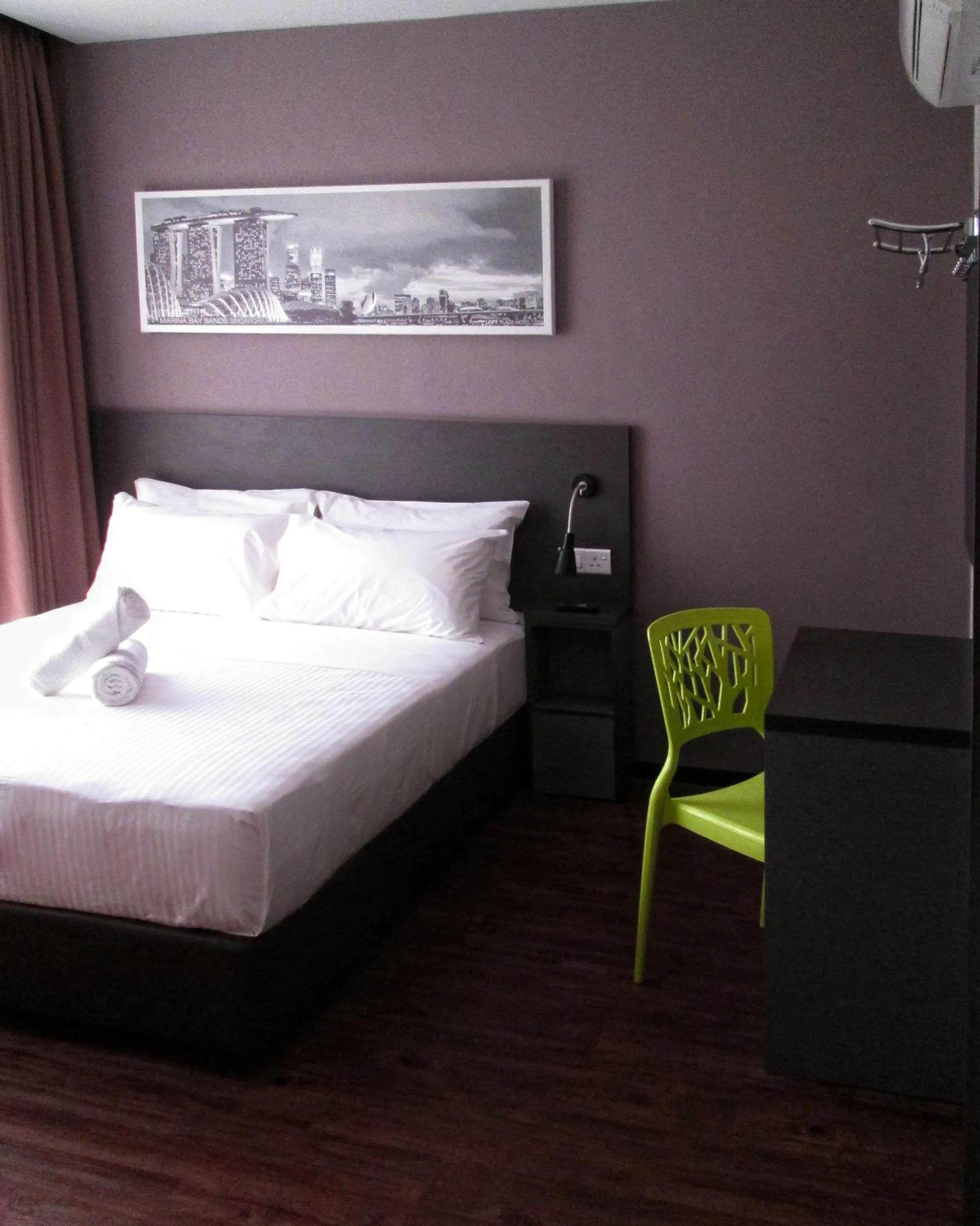 Bed in The Loft Plaza Hotel