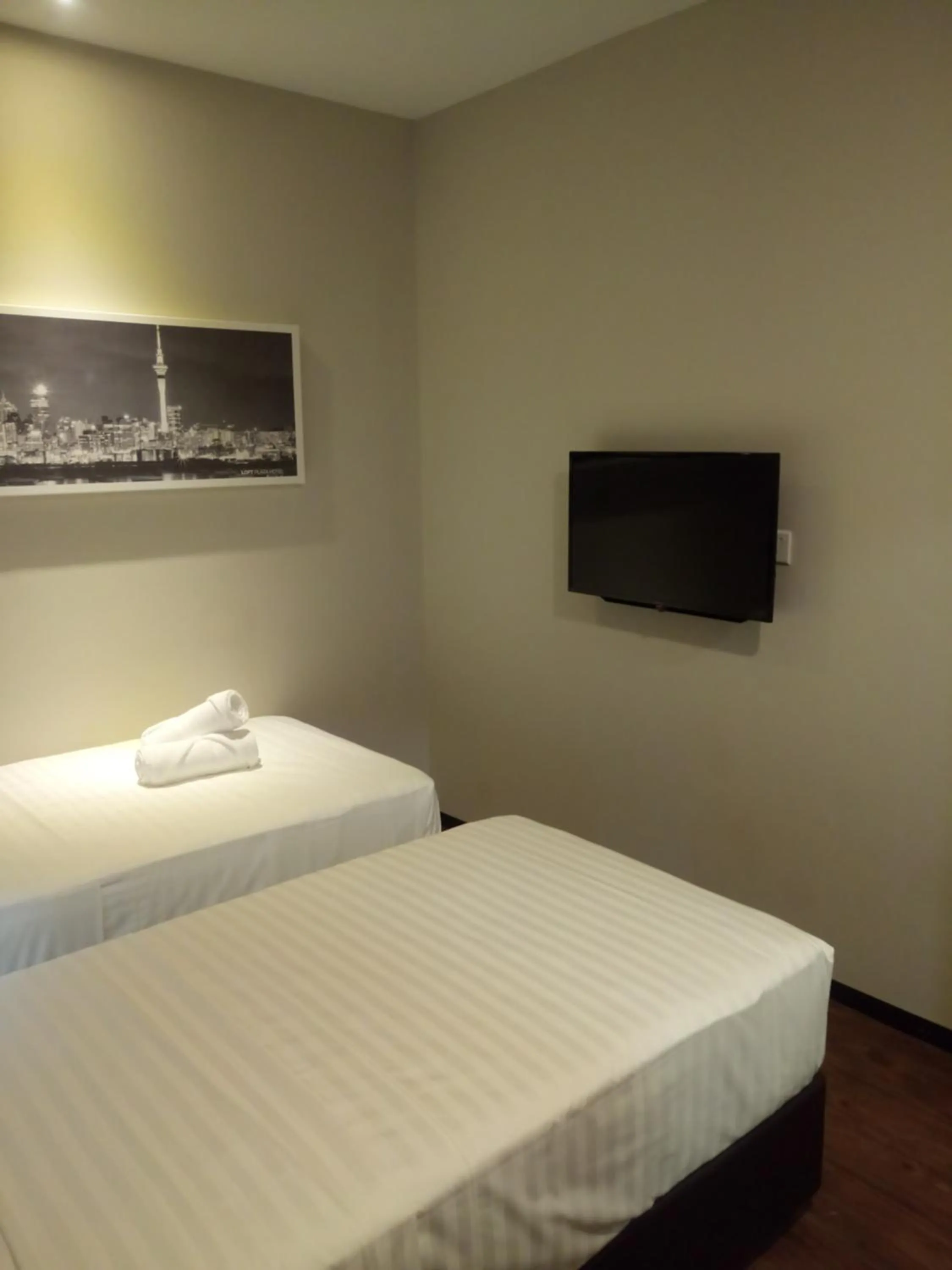 Bed in The Loft Plaza Hotel