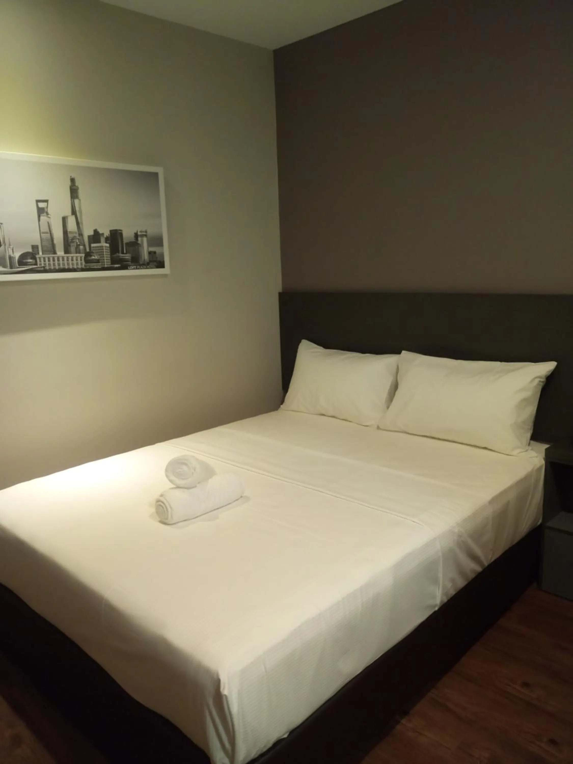 Bed in The Loft Plaza Hotel