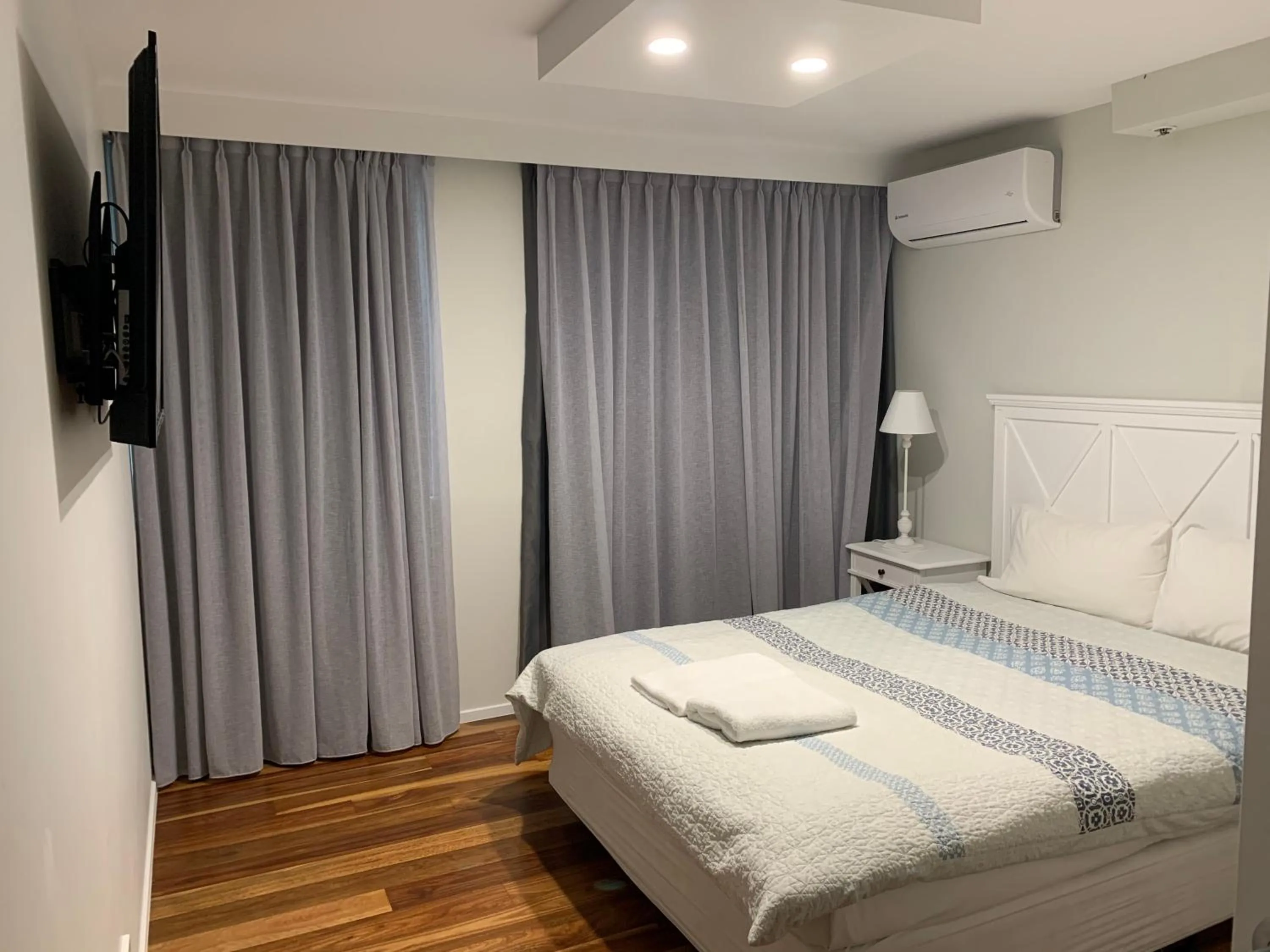 Bed in The Penthouses Apartments