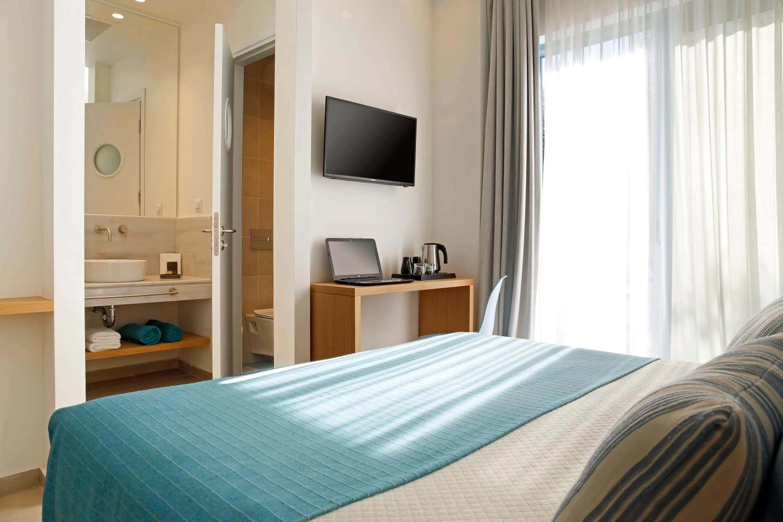 Bed in Oasis Beach Hotel