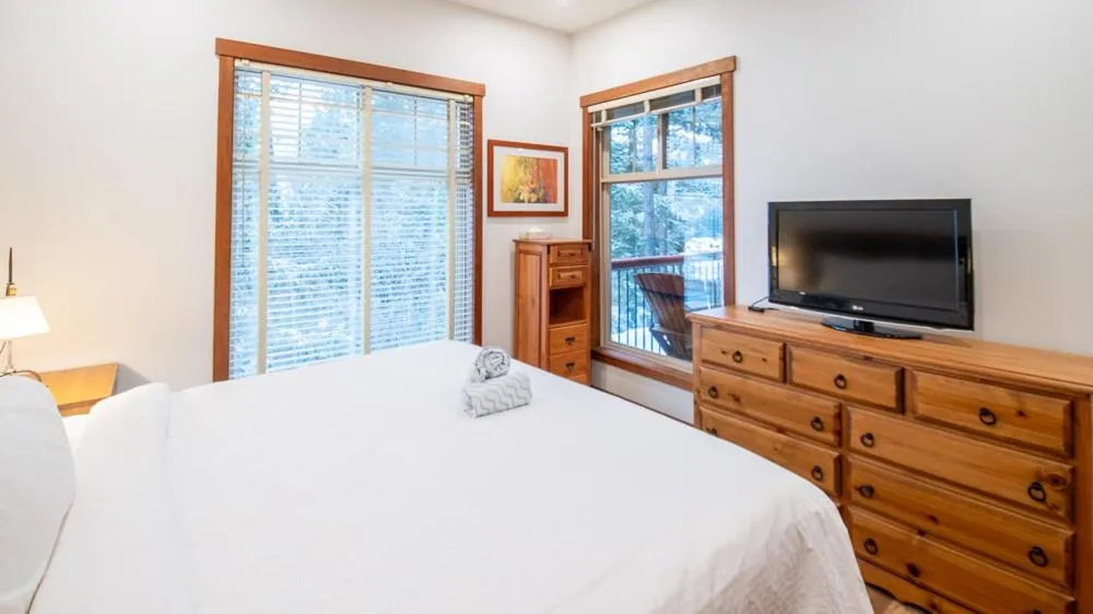 Bed in Snow Creek Lodge by Fernie Lodging Co