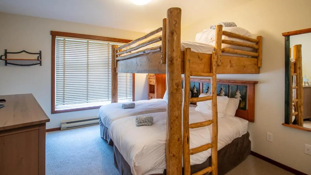 Bed in Snow Creek Lodge by Fernie Lodging Co