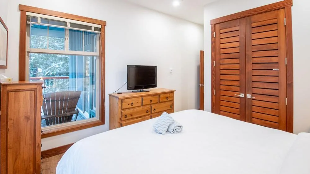 Bed in Snow Creek Lodge by Fernie Lodging Co