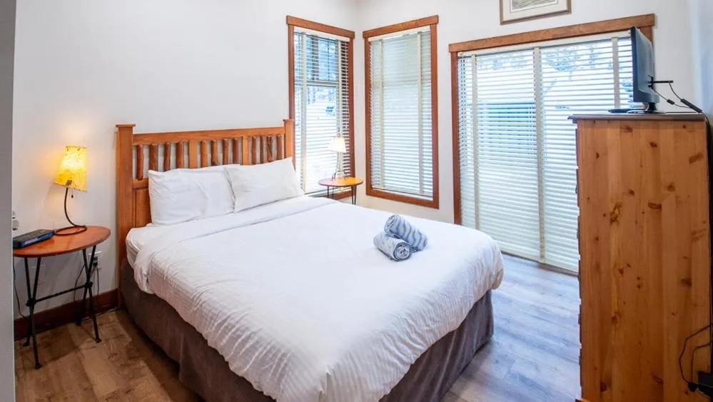 Bed in Snow Creek Lodge by Fernie Lodging Co