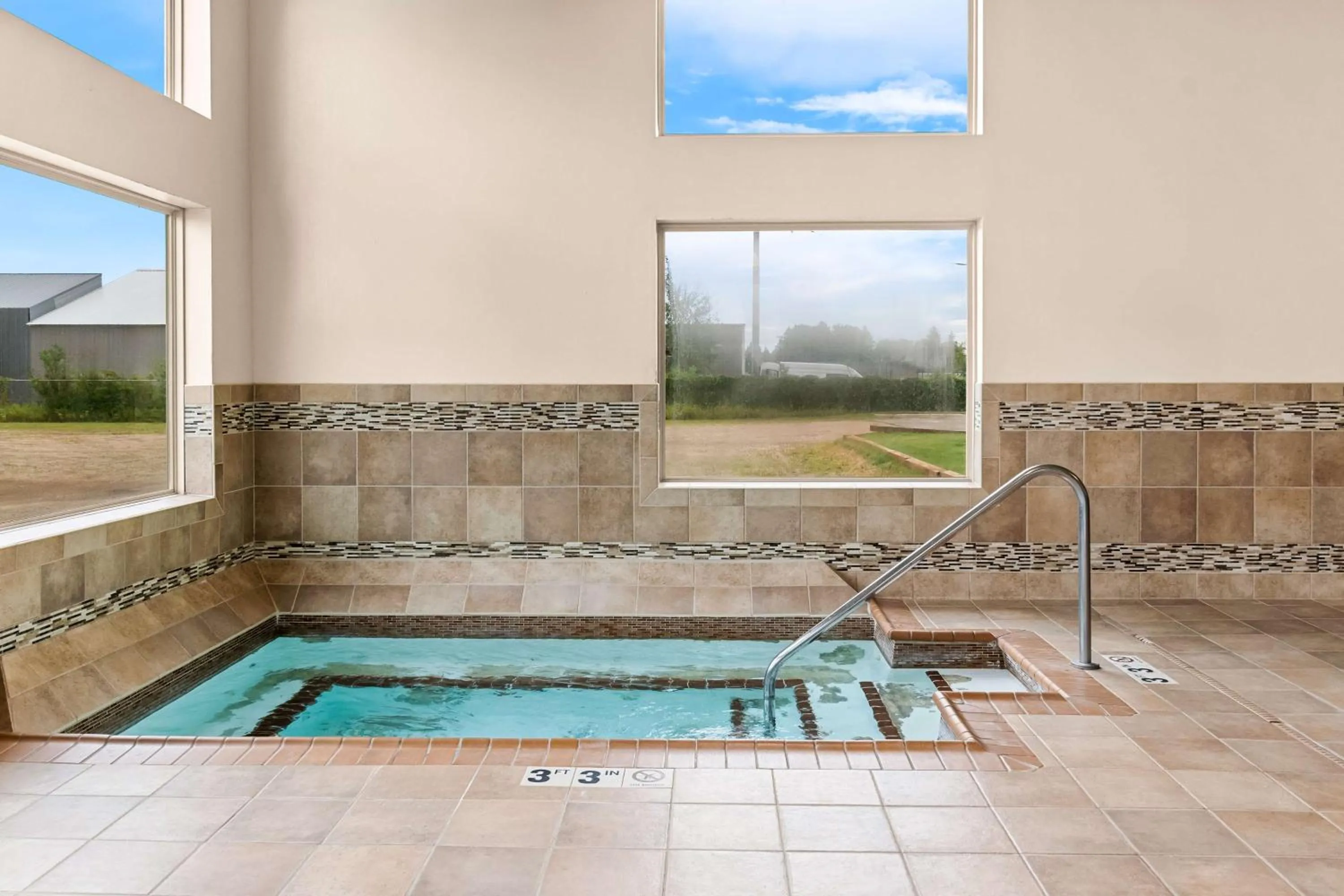 Pool view in Heartland Inn & Suites, SureStay Collection by Best Western