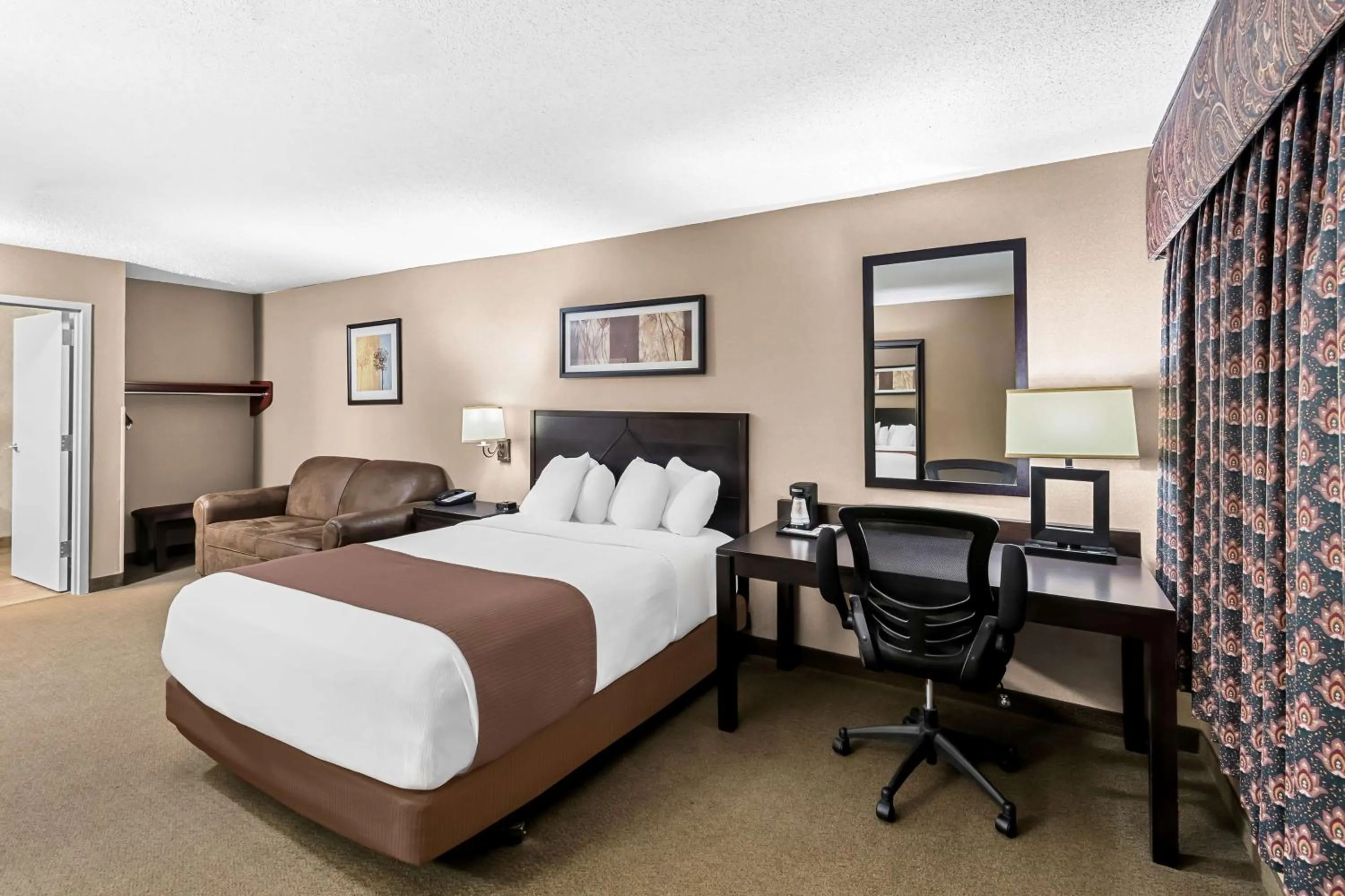 Bedroom, Bed in Heartland Inn & Suites, SureStay Collection by Best Western