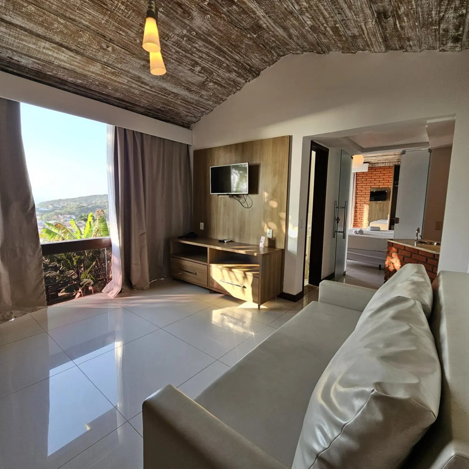 Communal lounge/ TV room, Bed in Costa do Sol Boutique Hotel