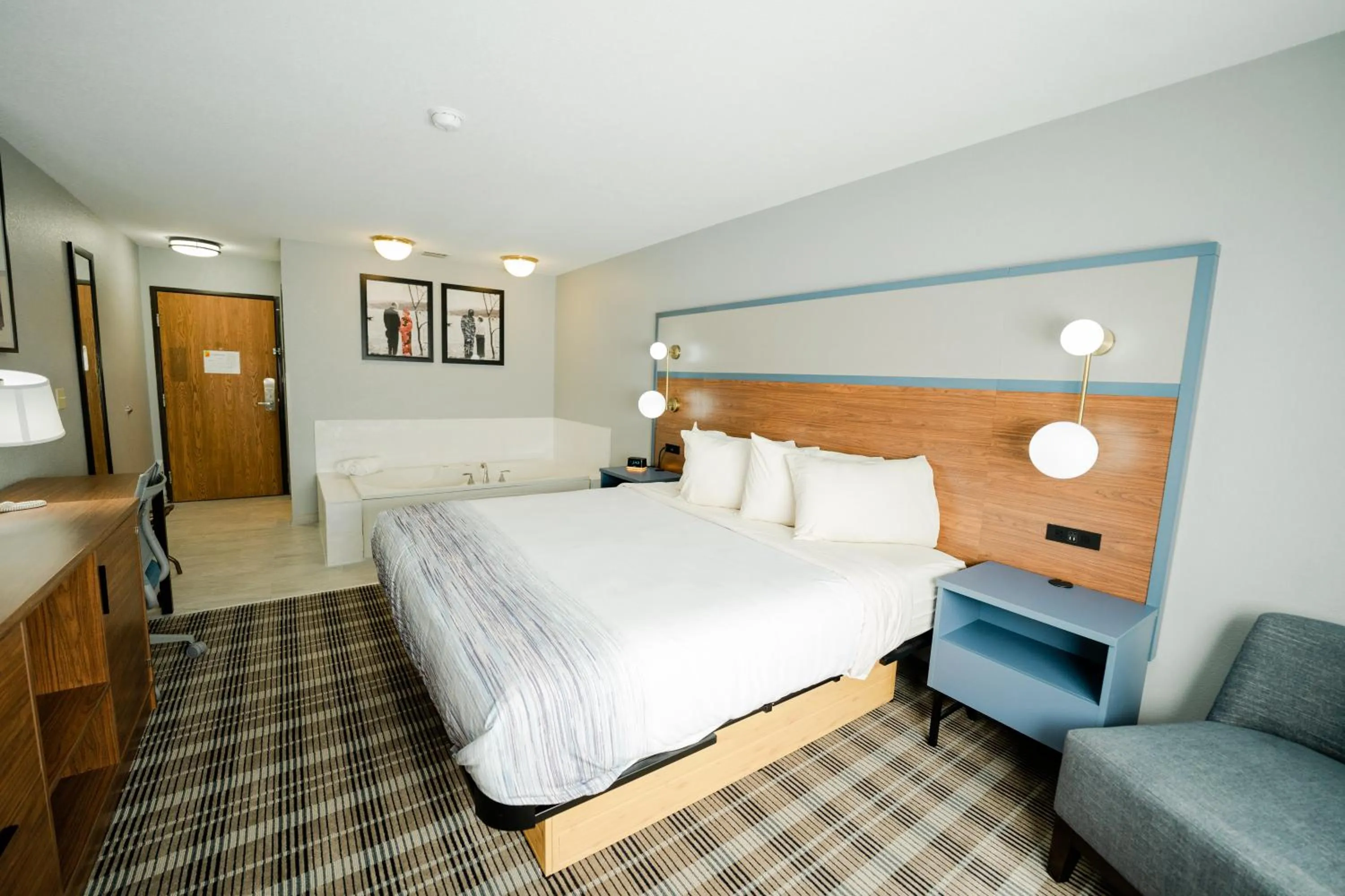 Bed in AmericInn by Wyndham Tomahawk