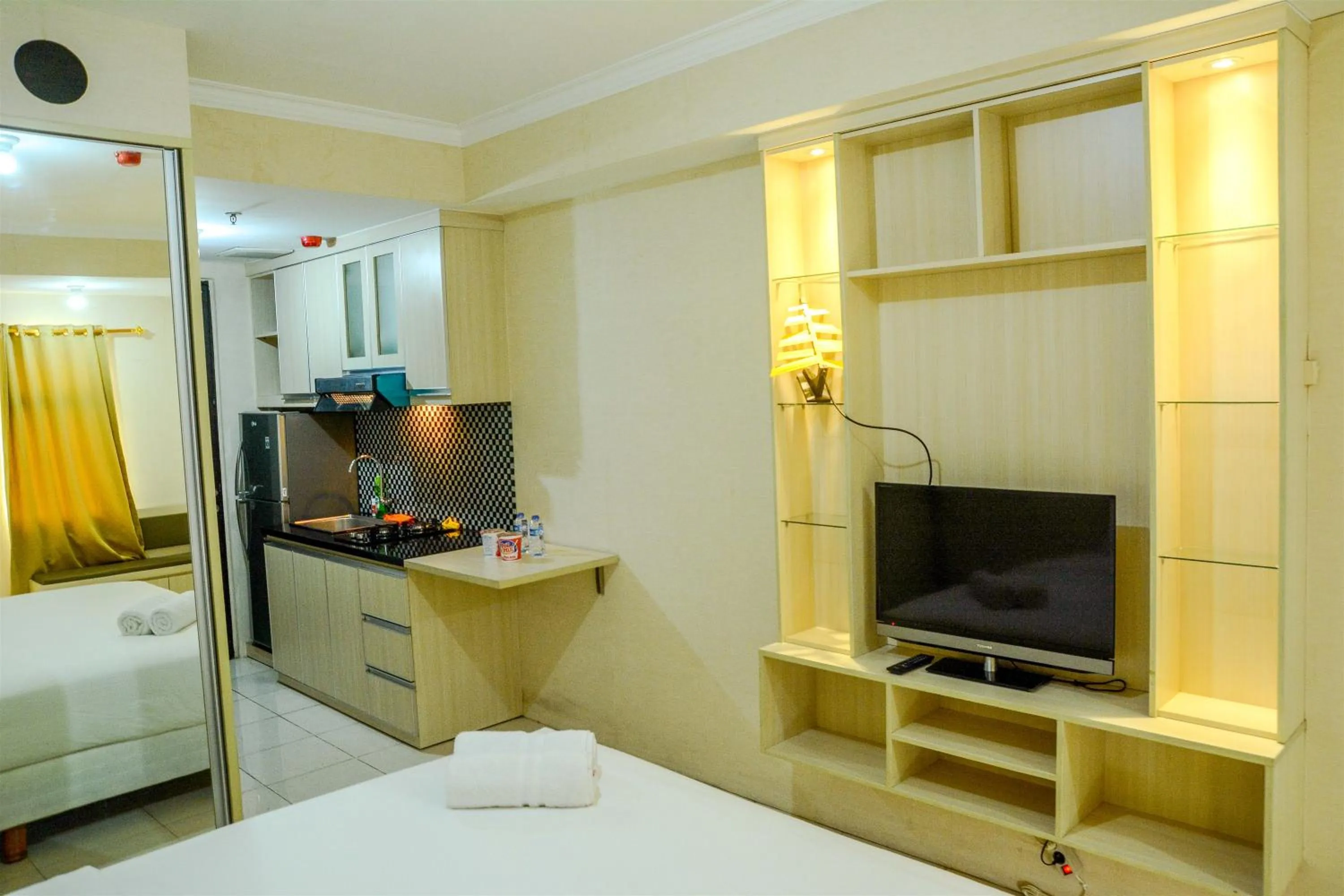 Property building, Bed in Modern Studio Room at Grand Serpong Apartment By Travelio