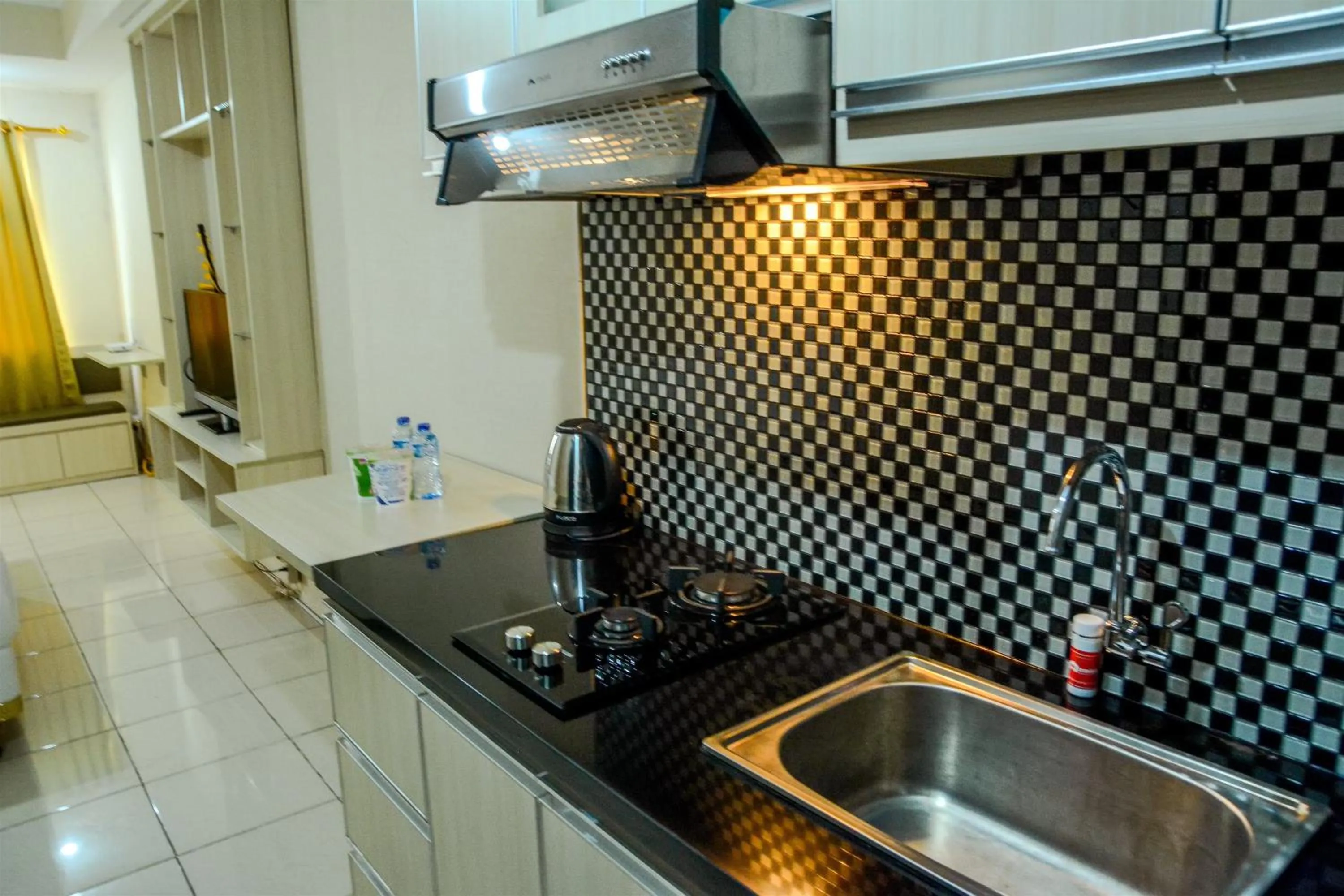 Minimalist Studio Room at Grand Serpong Apartment By Travelio