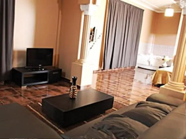 Communal lounge/ TV room in Sheva Hotel