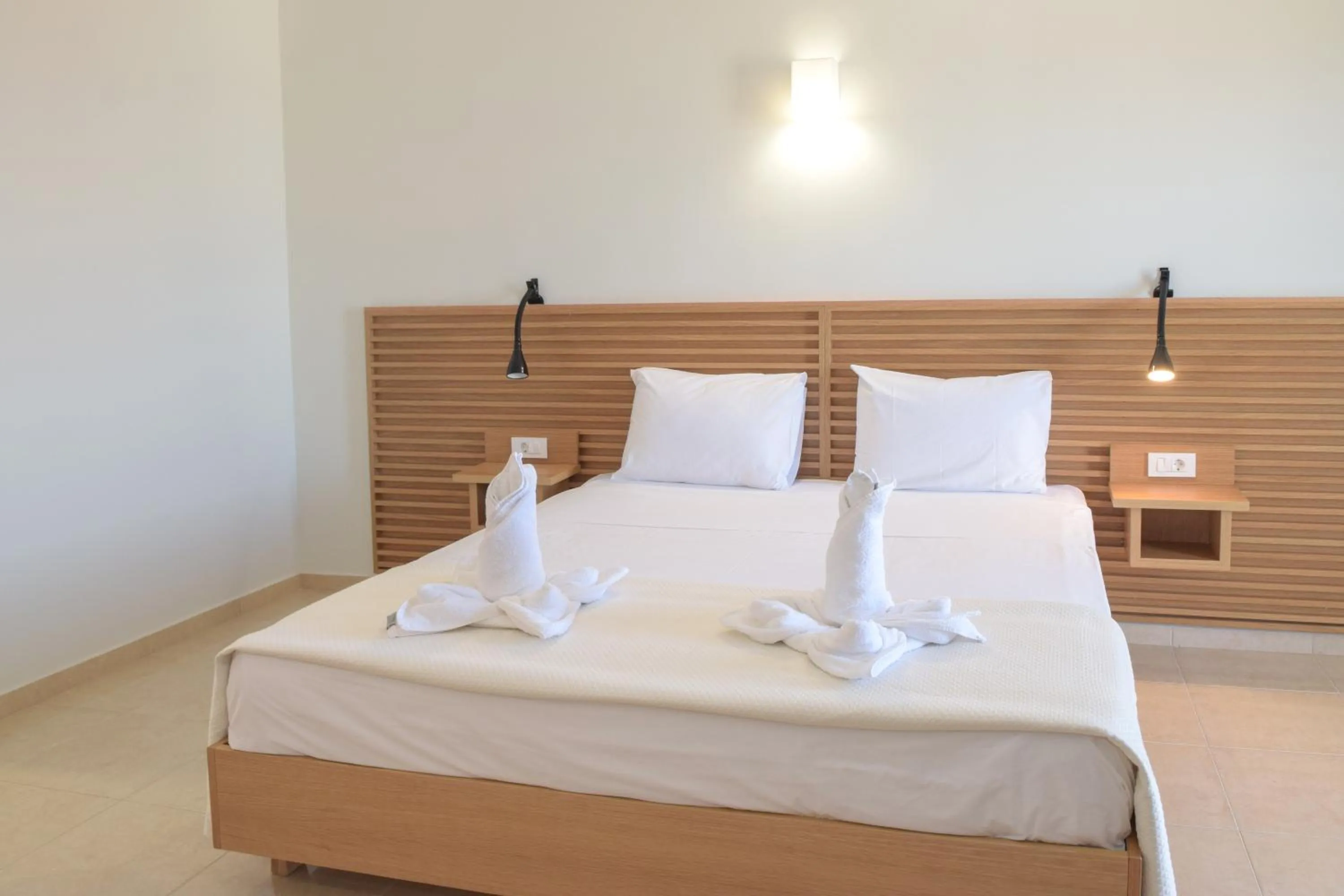 Bed in Mithos Premium Rooms