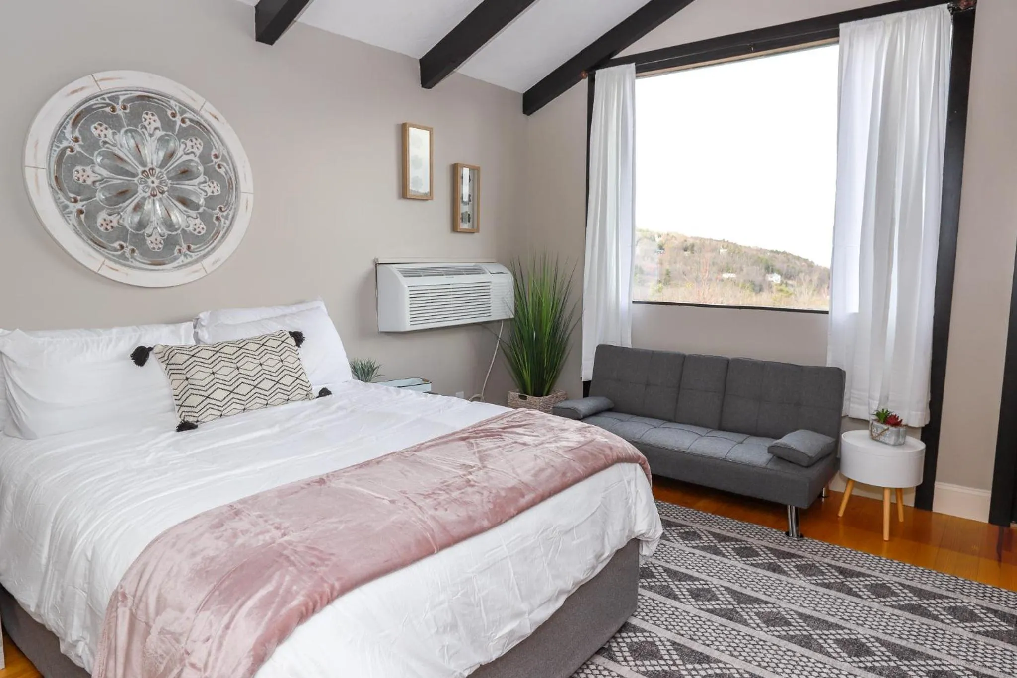 Bed in Gunstock Inn & Suites