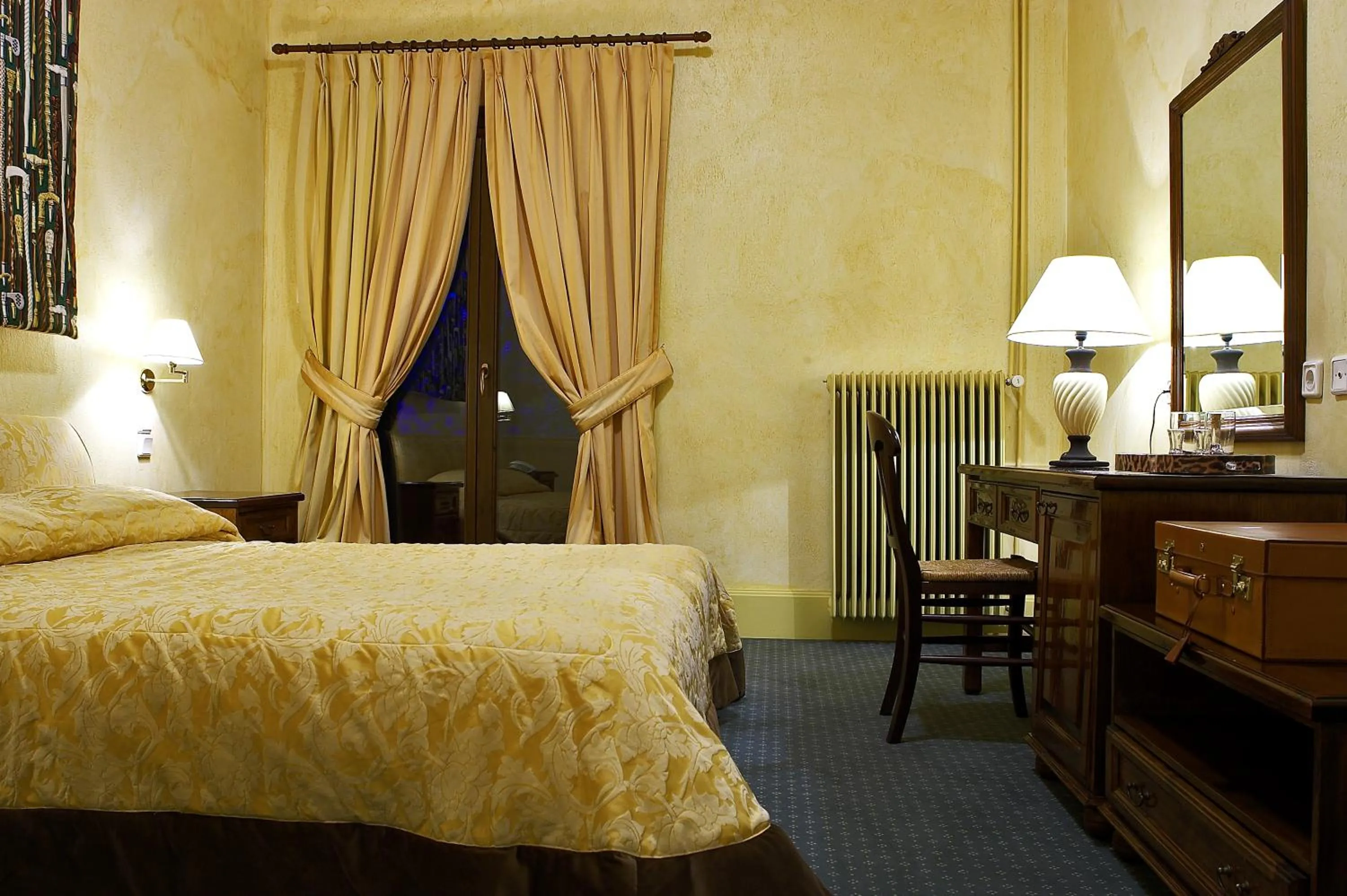 Bed in Country Club Hotel & Suites