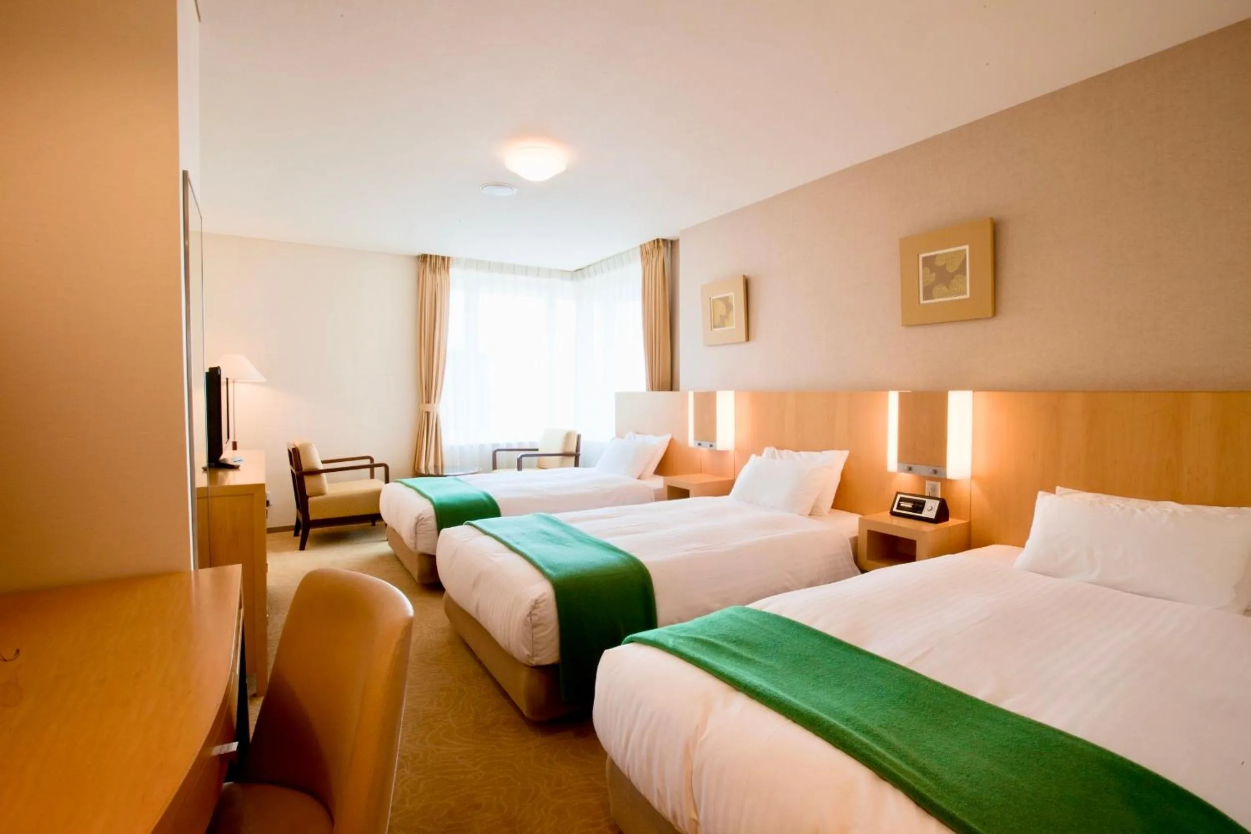 Bed in Hotel Kitano Plaza Rokkoso