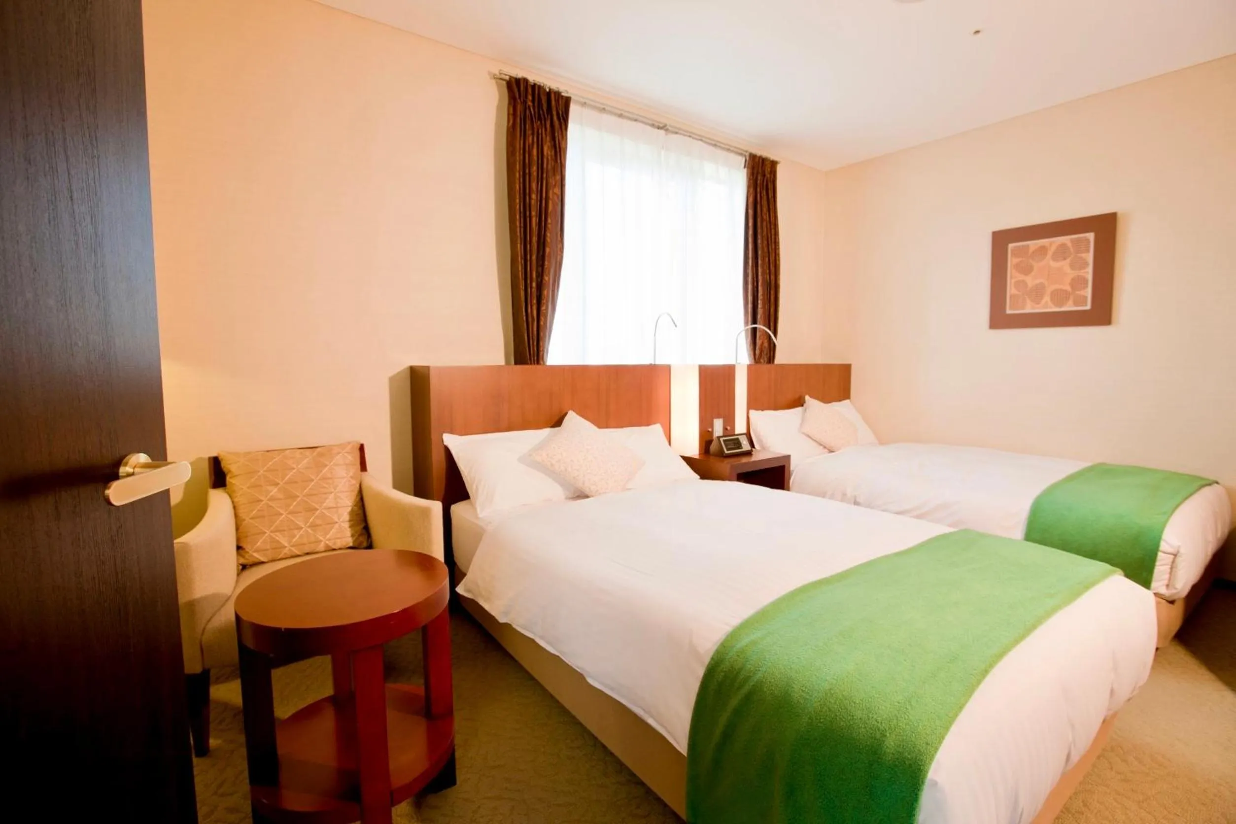 Bed in Hotel Kitano Plaza Rokkoso