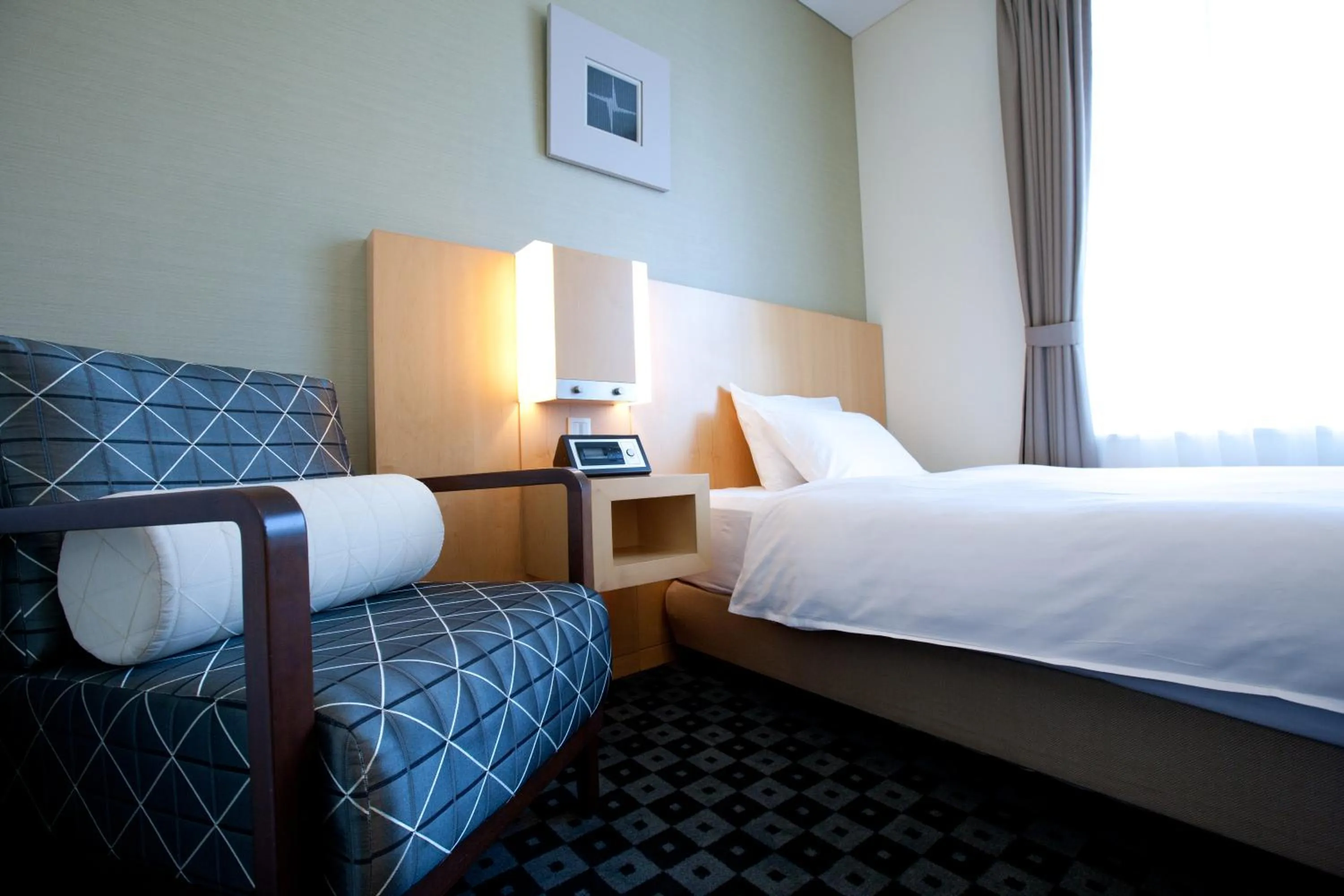 Bed in Hotel Kitano Plaza Rokkoso