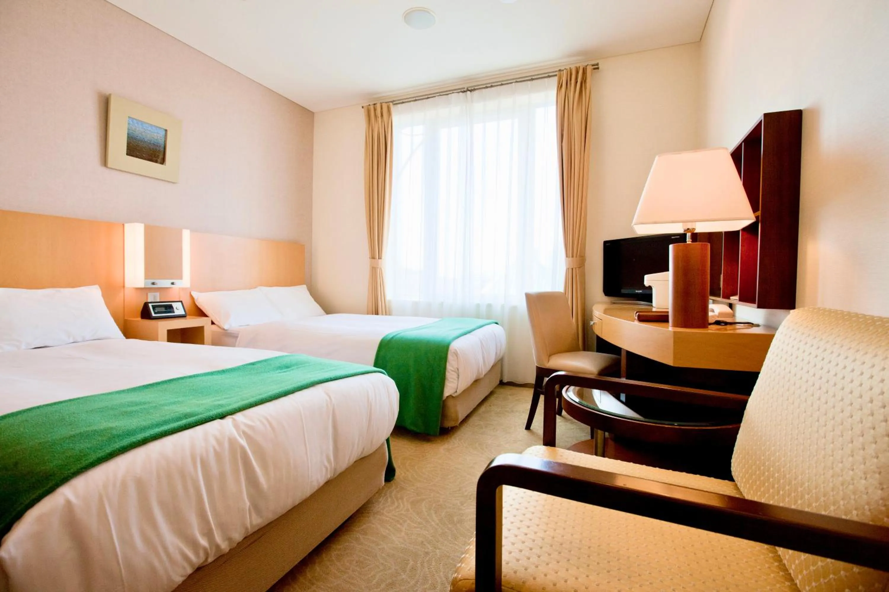 Bed in Hotel Kitano Plaza Rokkoso