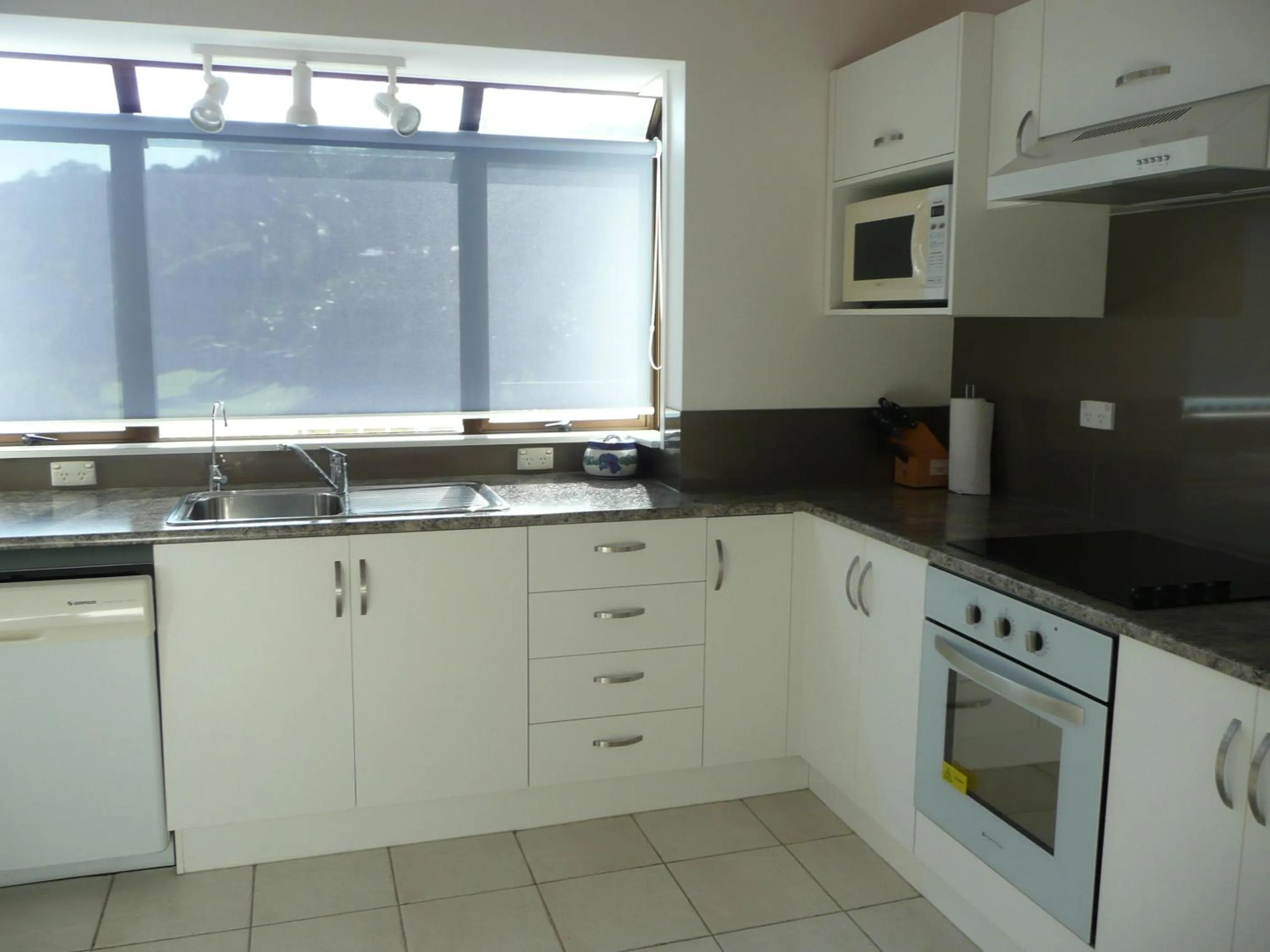 Kitchen or kitchenette in By the Bay Beachfront Apartments