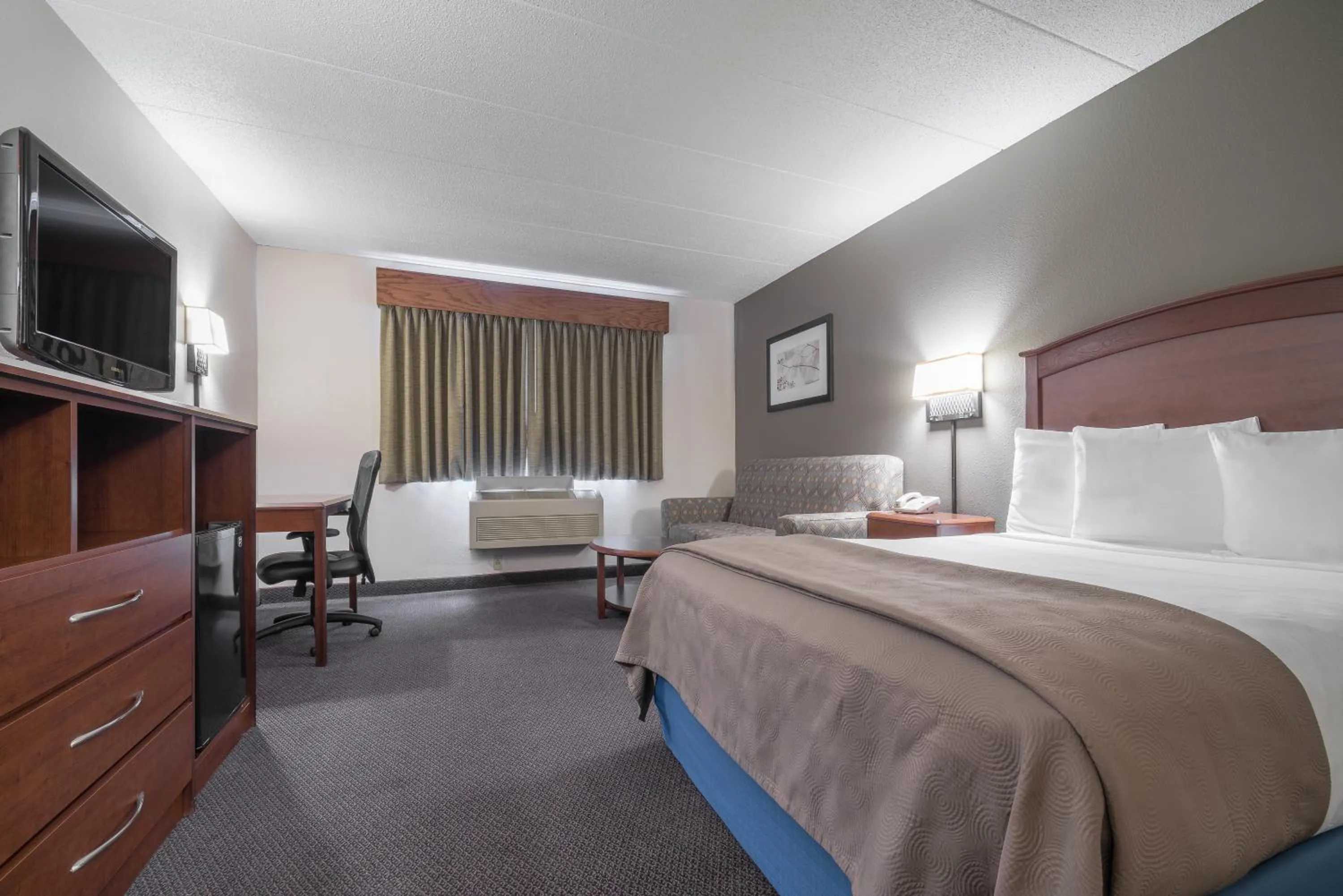 Decorative detail, Bed in AmericInn by Wyndham Hutchinson