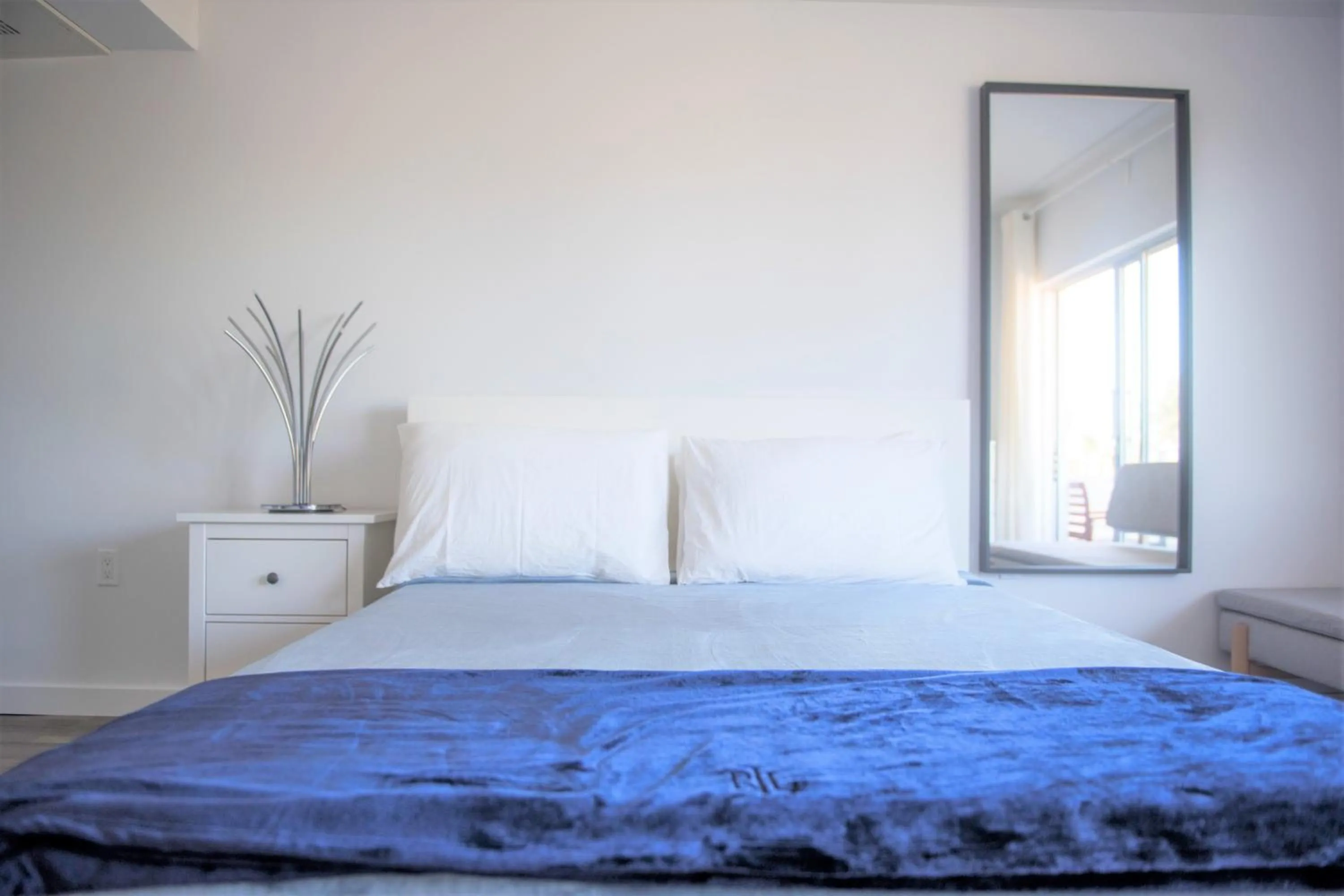 Bed in 12th & Ocean Suites by LuxUrban