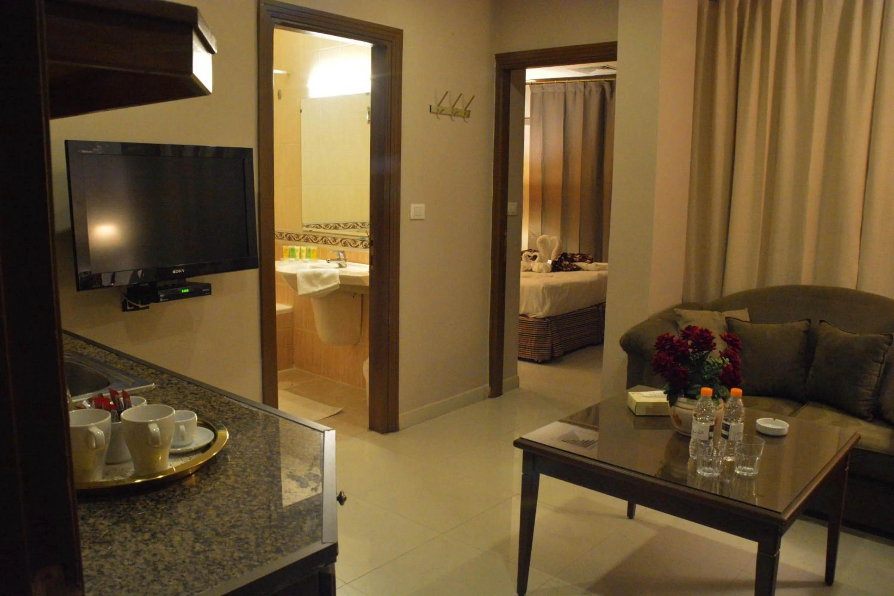 Living room, Bed in Capri Hotel Suites