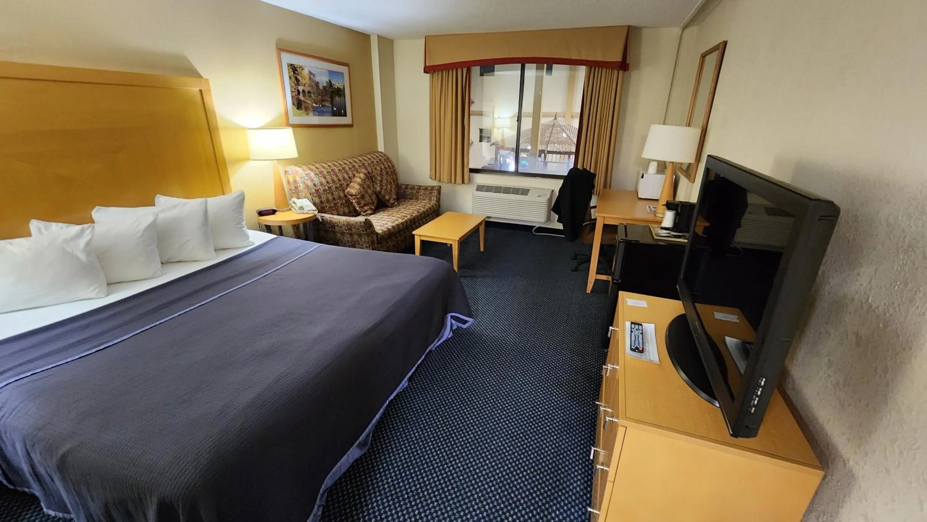 Bed in Katahdin Inn & Suites